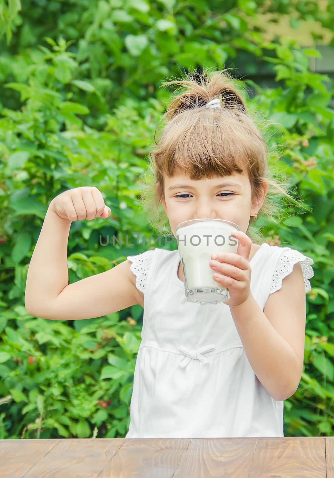 The child drinks milk and cookies. Selective focus.