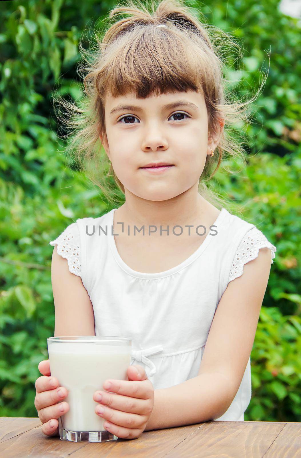 The child drinks milk and cookies. Selective focus.