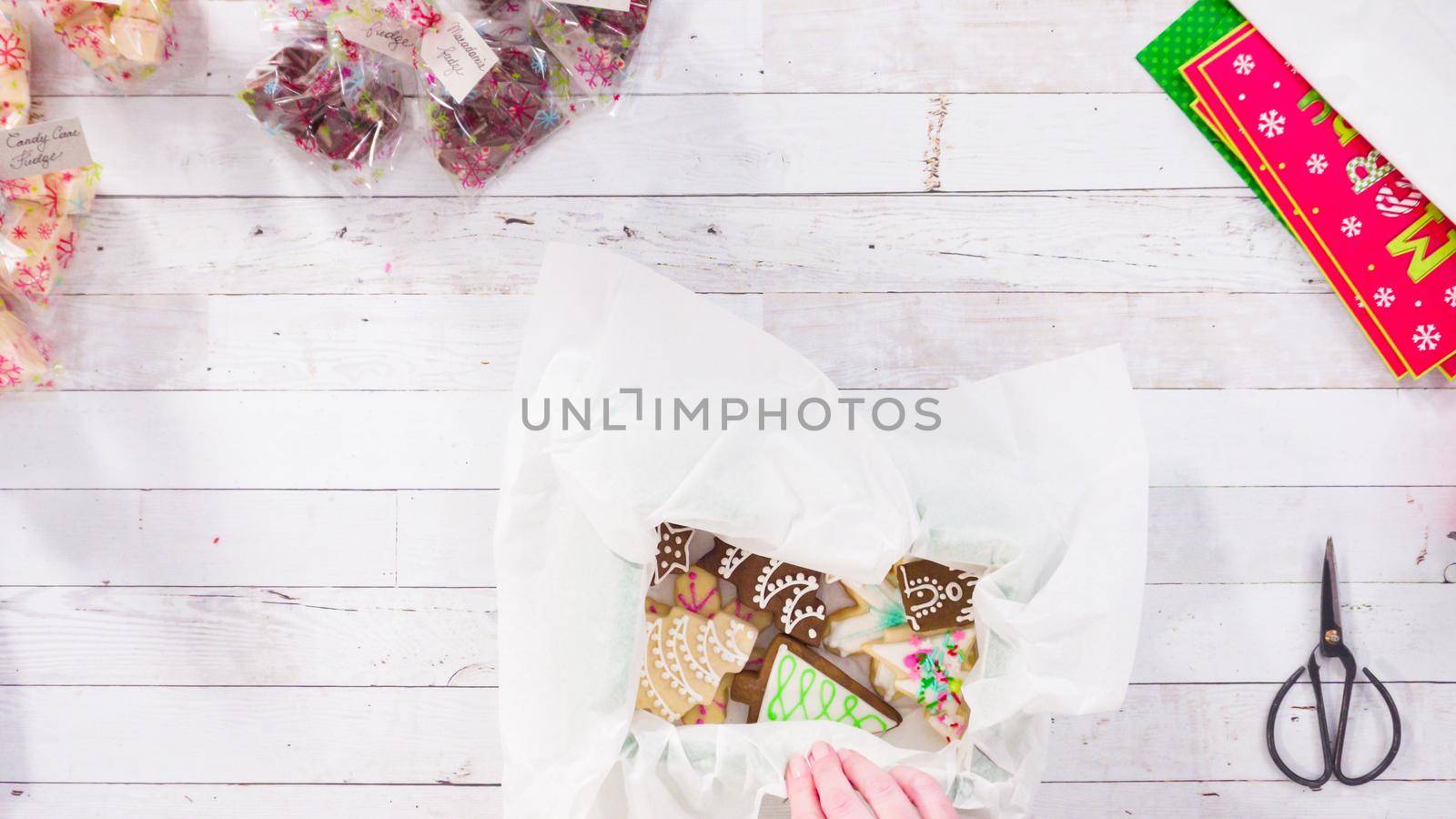 Flat lay. Step by step. Packaging homemade fudge and cookies into a Christmas gift box.
