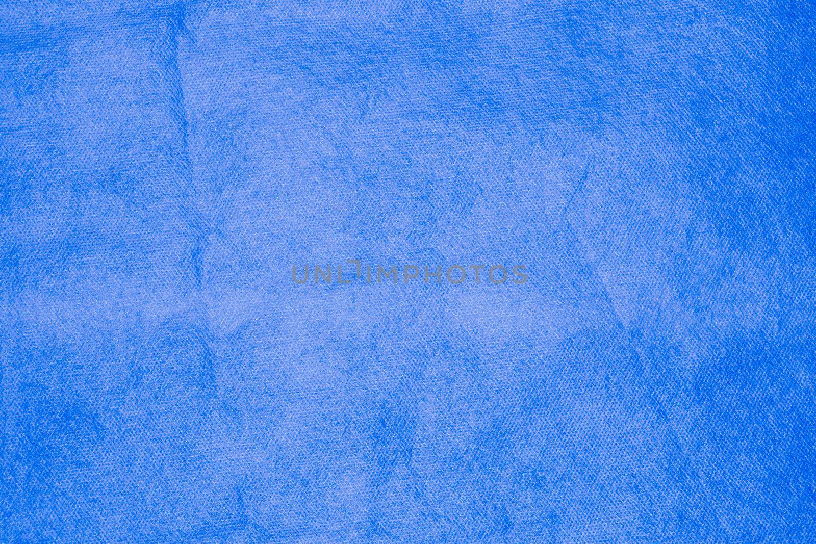 Spongebond texture in blue. Blue nonwoven polypropylene material texture background.