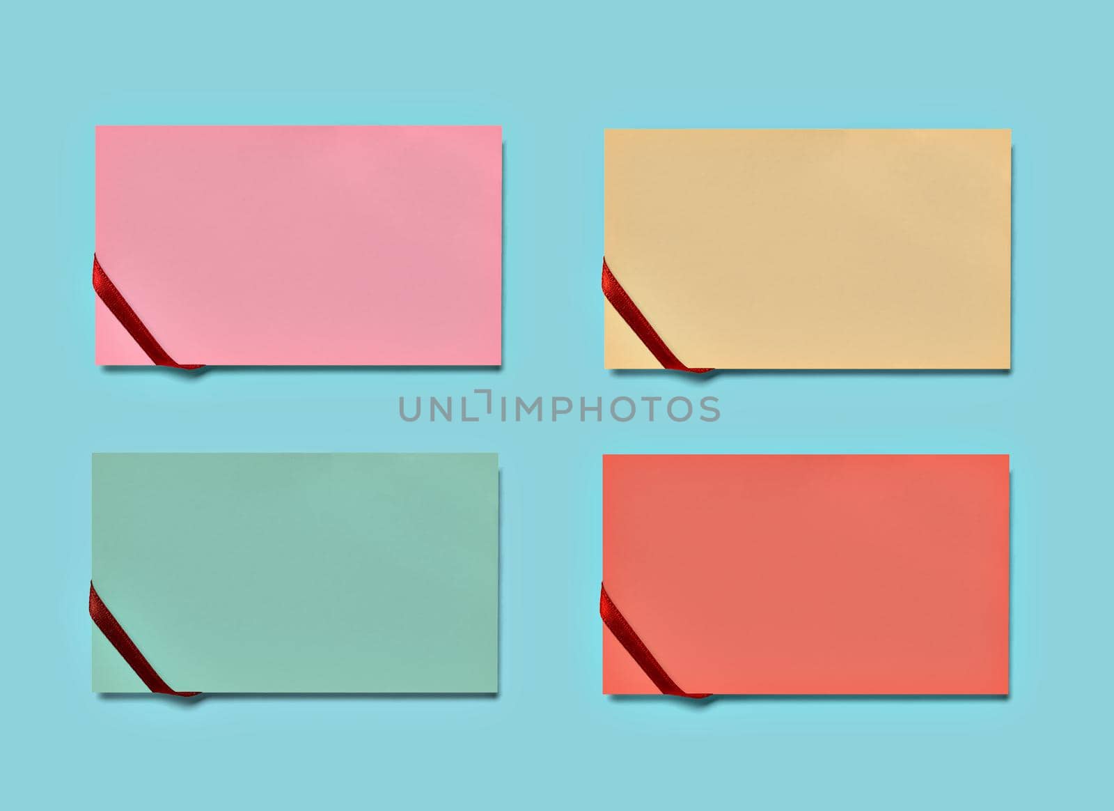 close up of a note paper greeting card with ribbon bow on pastel color background background