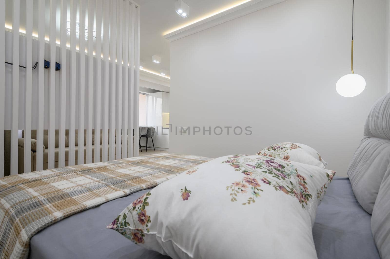 Stylish interior of gray and white bedroom with comfortable double bed