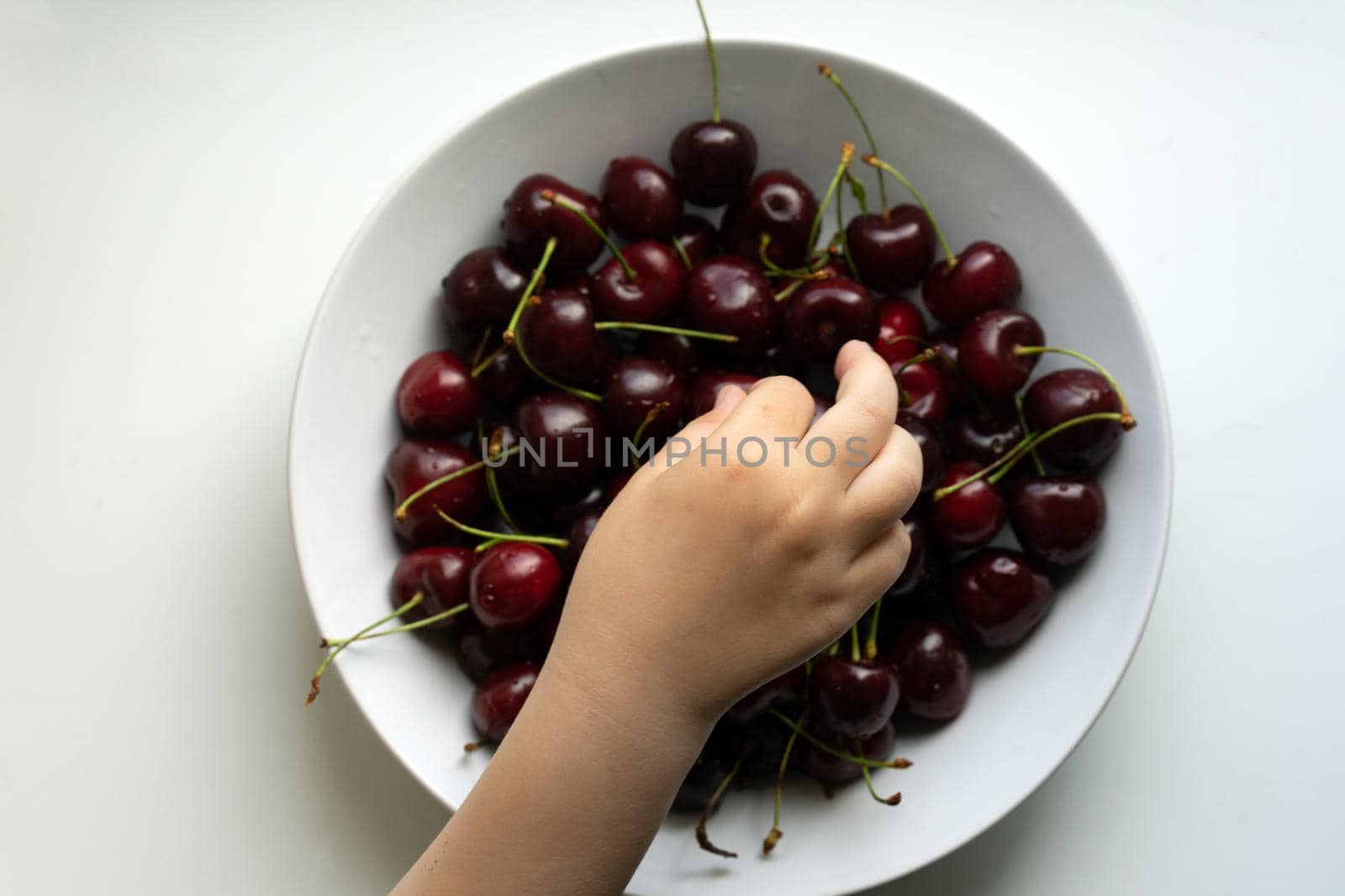 Healthy eating and food concept - cherries in white bowl. . High quality photo