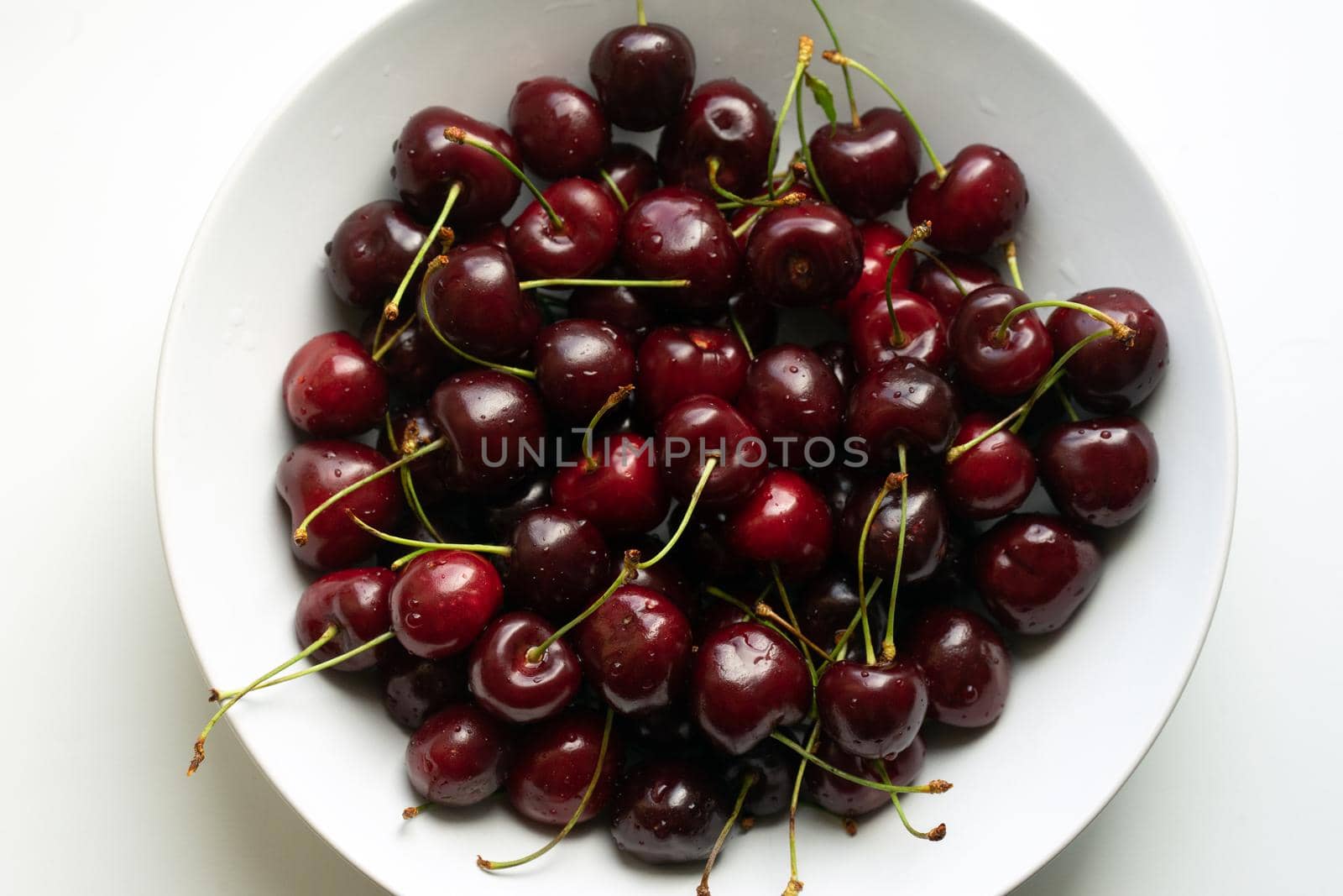 Healthy eating and food concept - cherries in white bowl. . High quality photo
