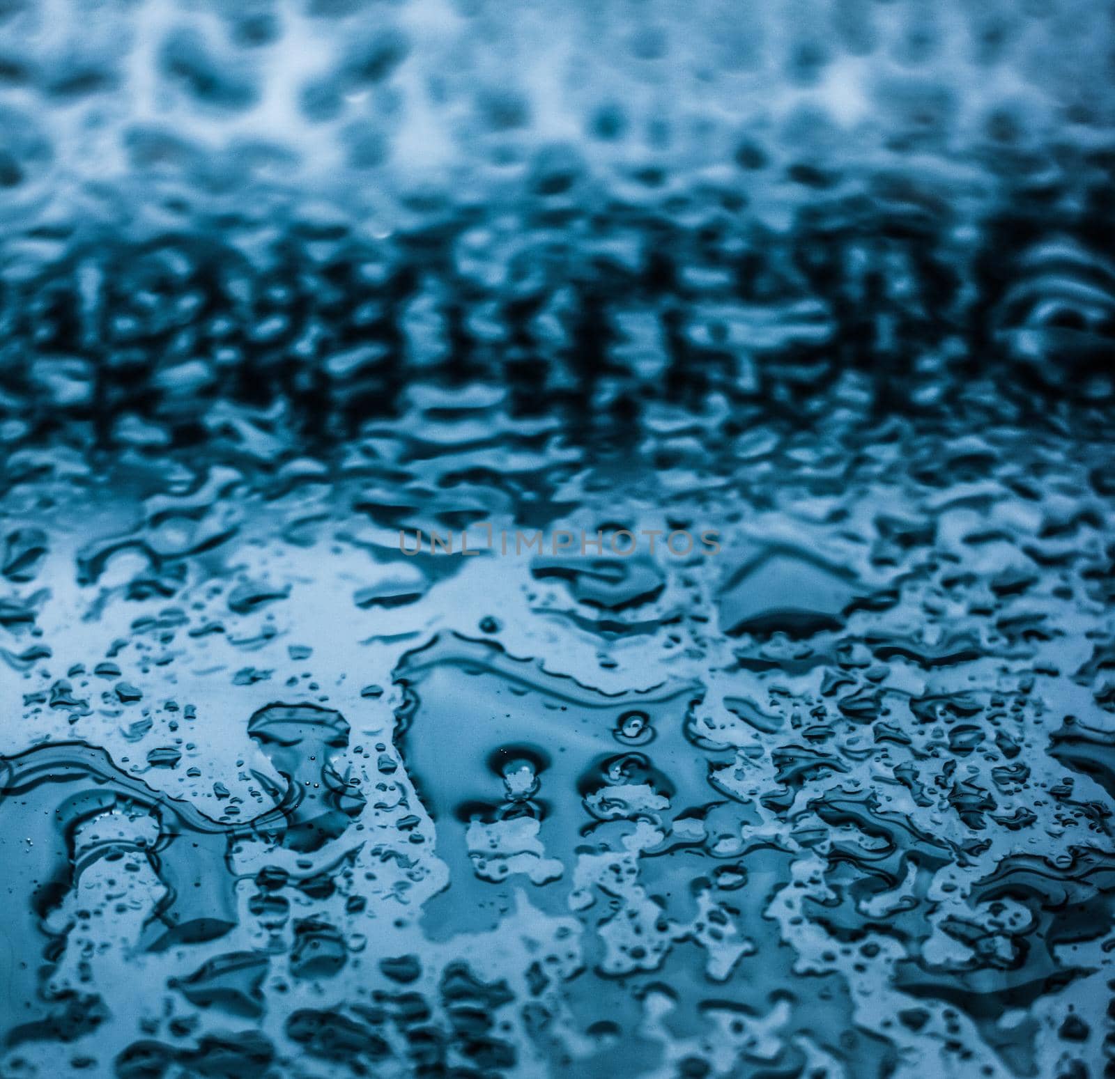 Liquid, wet and zen concept - Water texture abstract background, aqua drops on blue glass as science macro element, rainy weather and nature surface art backdrop for environmental brand design