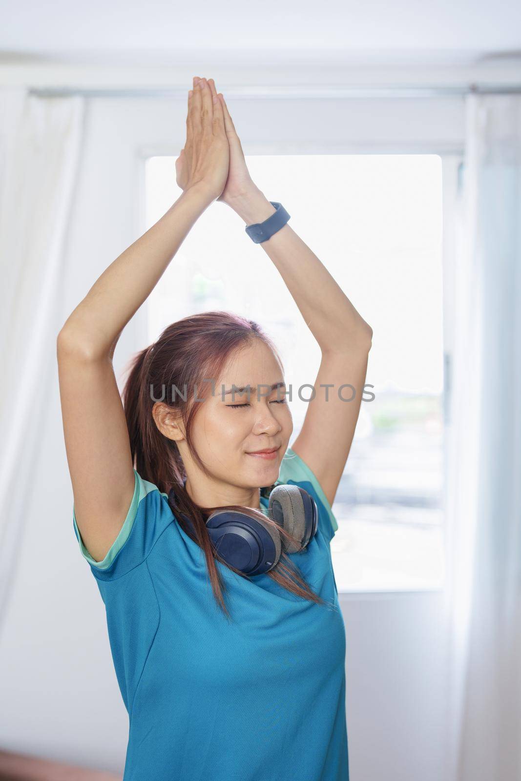 stress relief, muscle relaxation, breathing exercises, exercise, meditation, portrait of Young Asian woman relaxing her body from office work by practicing yoga by watching online tutorials