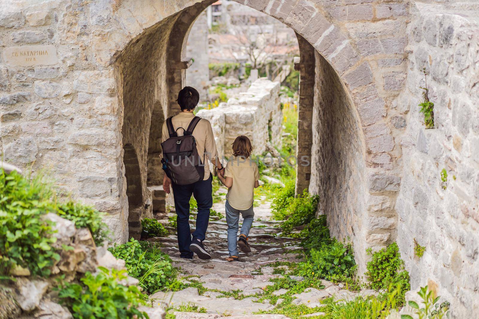 Dad and son tourists walks through the old town of Bar in Montenegro. Happy tourist walks in the mountains. Suburbs of the city of Bar, Montenegro, Balkans. Beautiful nature and landscape.