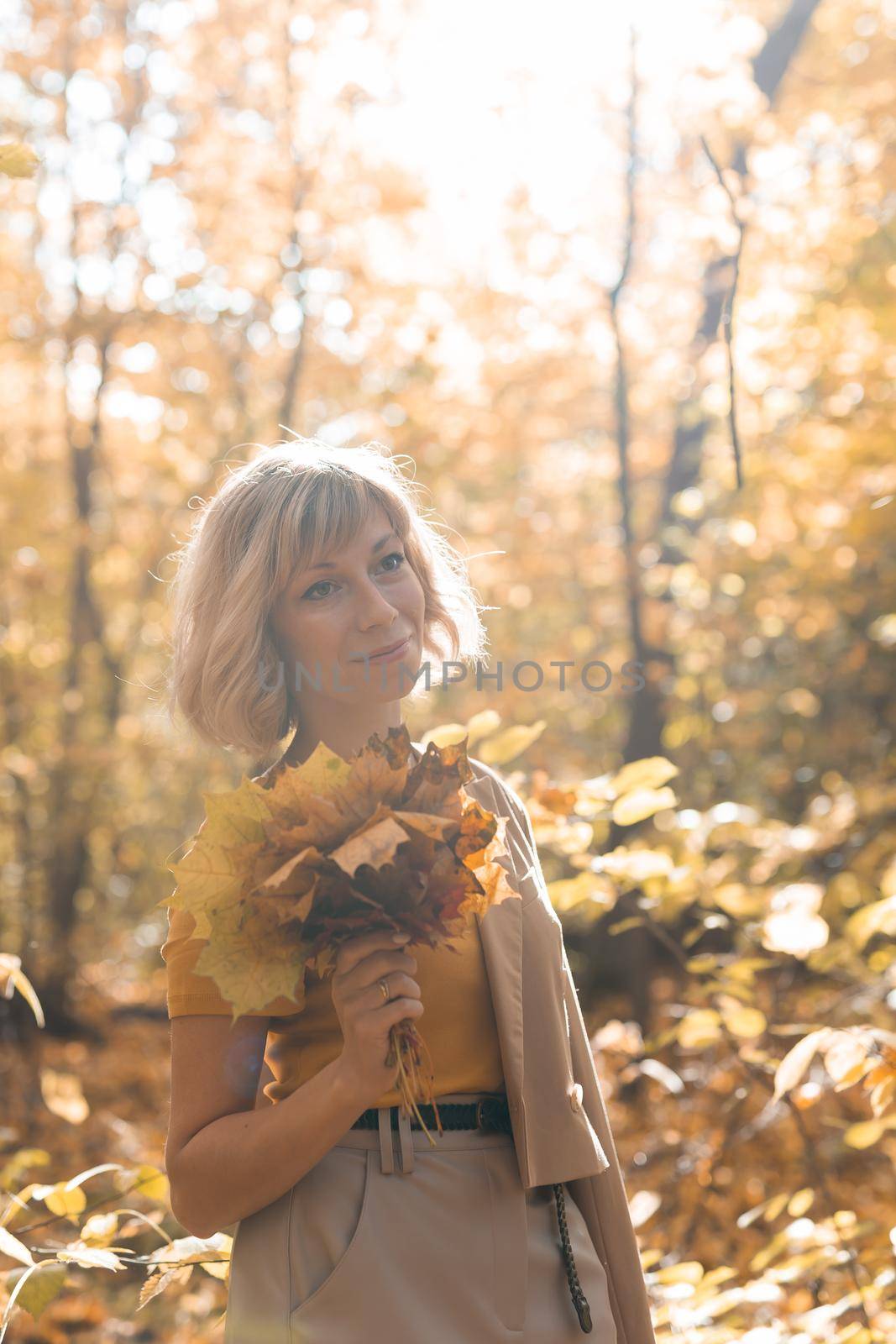 Autumn woman in fall season park. Warm sunny weather. by Satura86