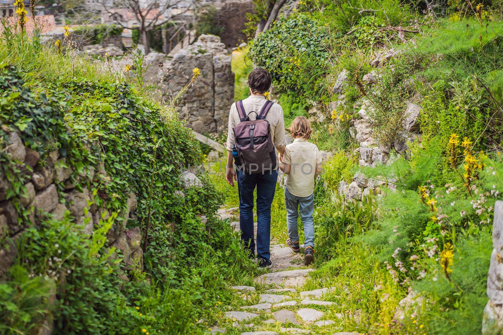 Dad and son tourists walks through the old town of Bar in Montenegro. Happy tourist walks in the mountains. Suburbs of the city of Bar, Montenegro, Balkans. Beautiful nature and landscape.
