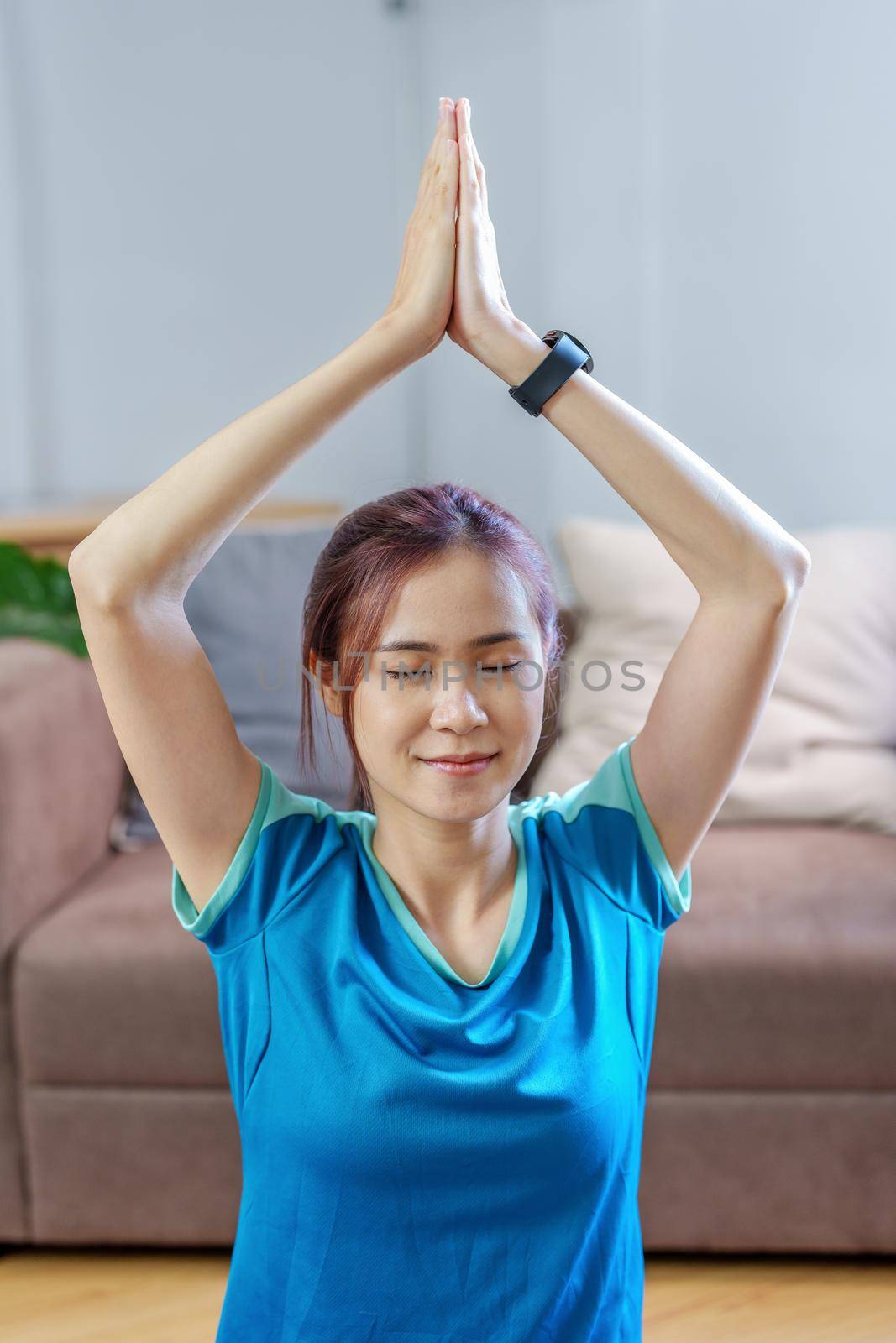 stress relief, muscle relaxation, breathing exercises, exercise, meditation, portrait of Young Asian woman relaxing her body from office work by practicing yoga by watching online tutorials