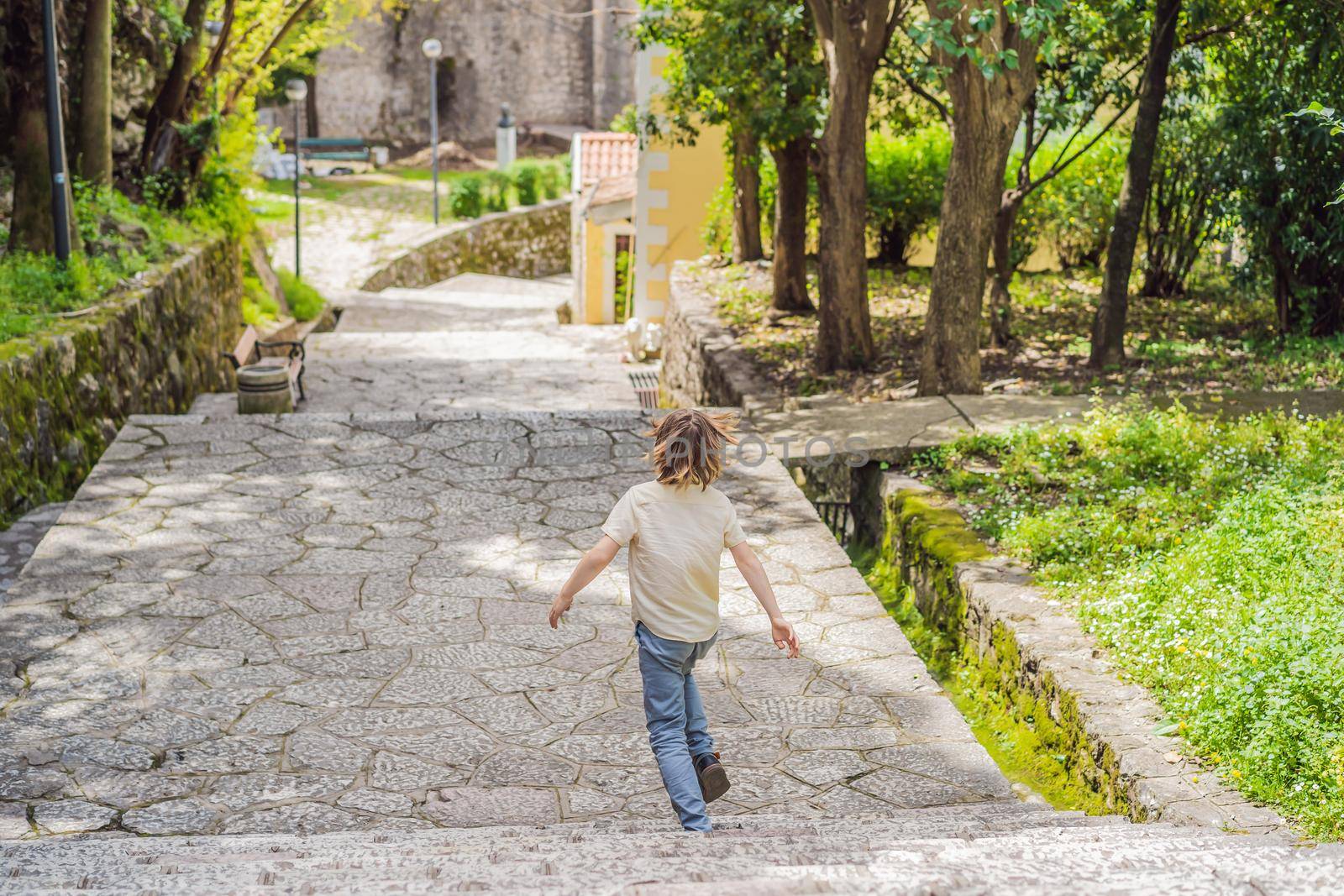 Boy tourist in Herceg Novi old town. Historical and touristic center of Herceg Novi. Montenegro.