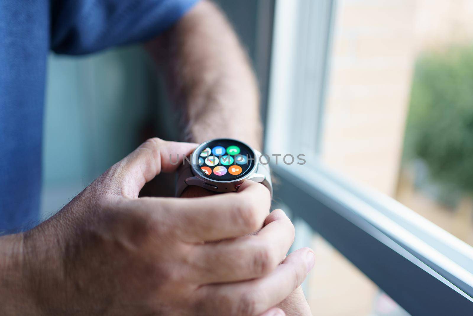 Granada, Andalusia, Spain - September 28th, 2022: Man using the app screen of the new Samsung Watch 5 Pro.