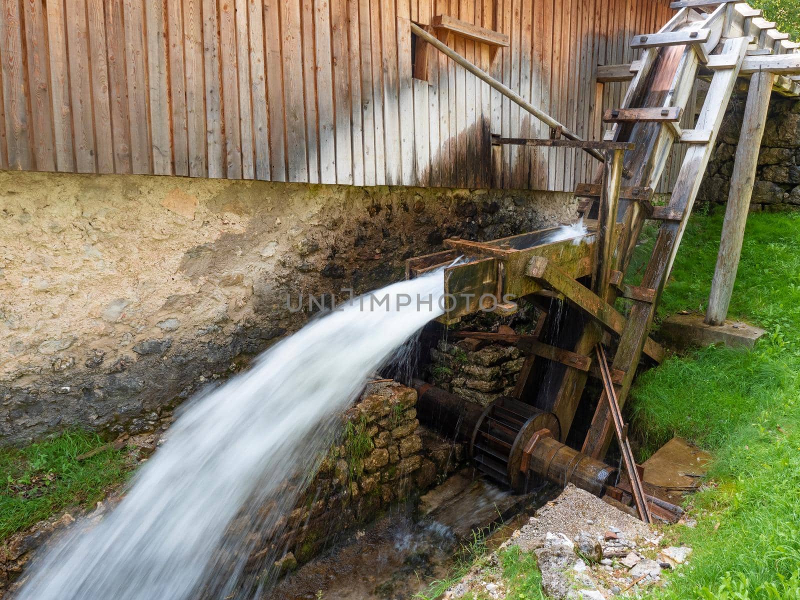 The power of the water spins the old watermill of a sawmill.  by rdonar2