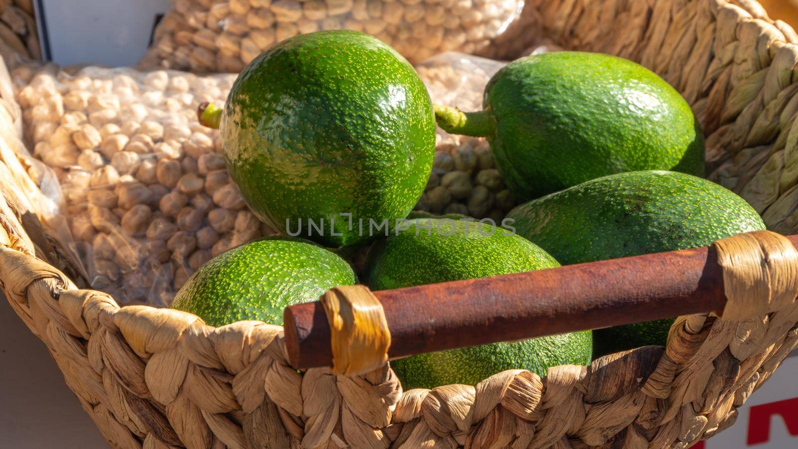 Avocados and chickpeas in a wicker basket, vegetables and legumes by voktybre