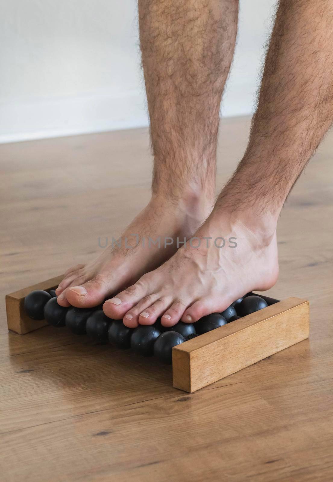 Man giving himself a foot massage at home.