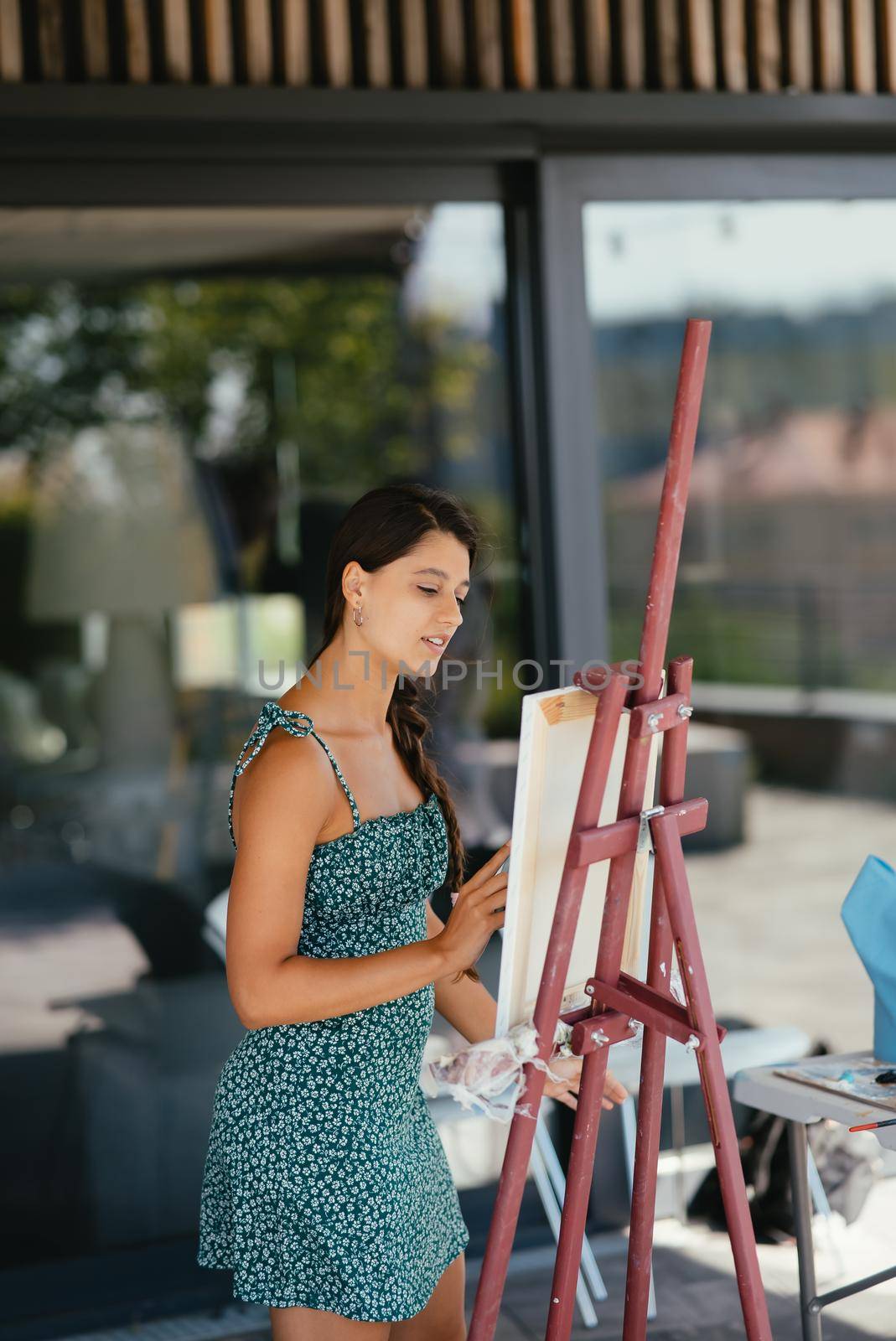 Female artist painting picture in workshop