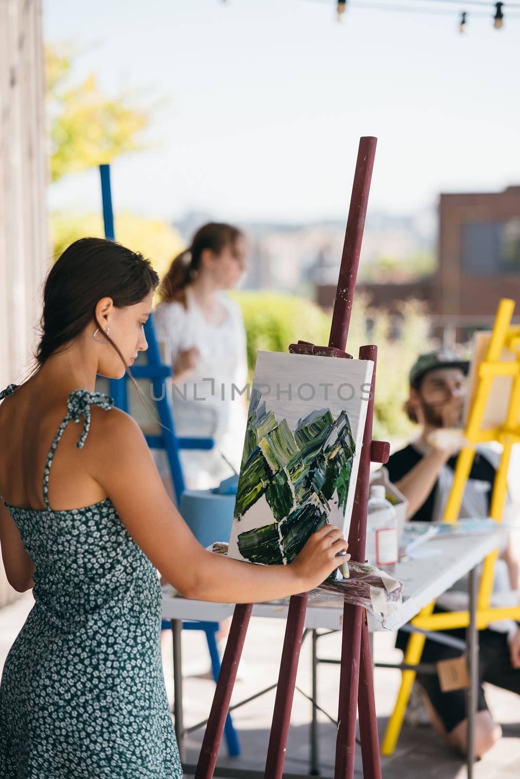 Female artist painting picture in workshop