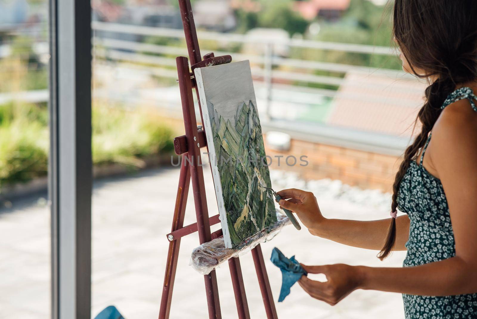 Female artist painting picture in workshop