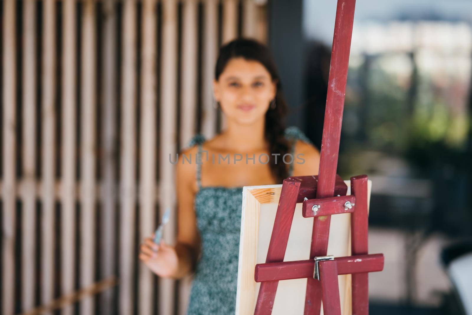 Female artist painting picture in workshop