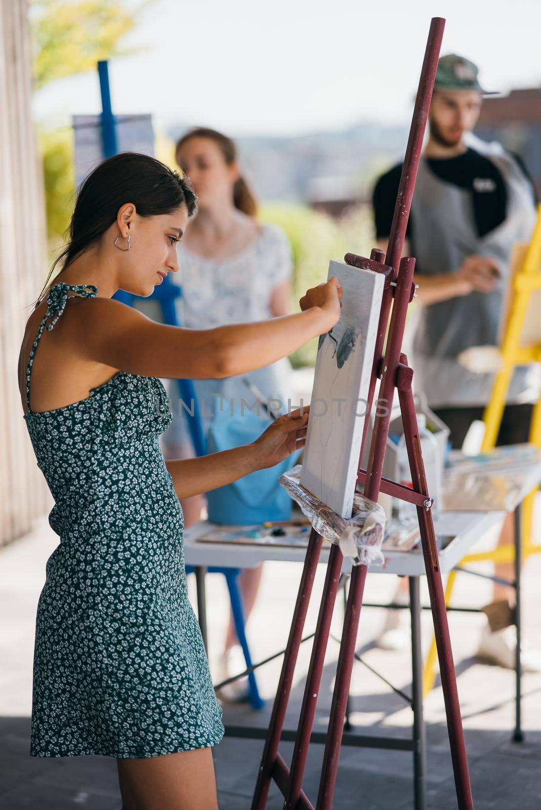 Female artist painting picture in workshop