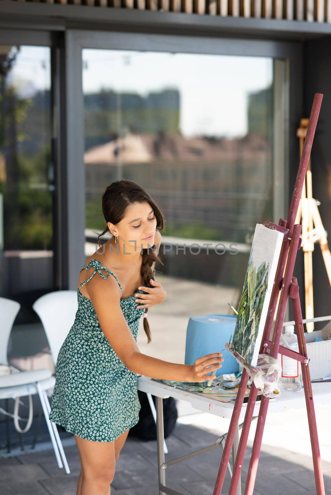 Female artist painting picture in workshop
