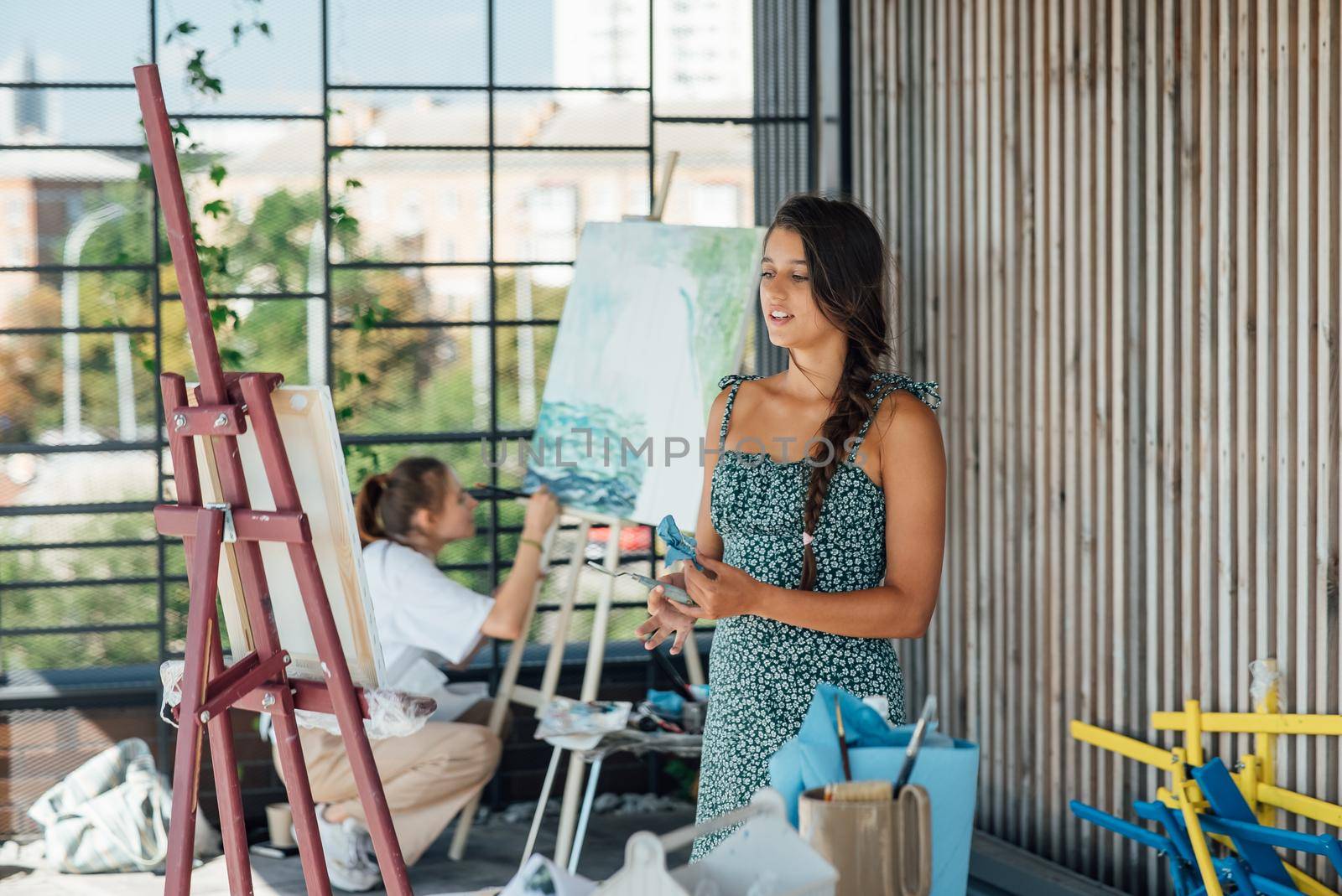 Female artist painting picture in workshop