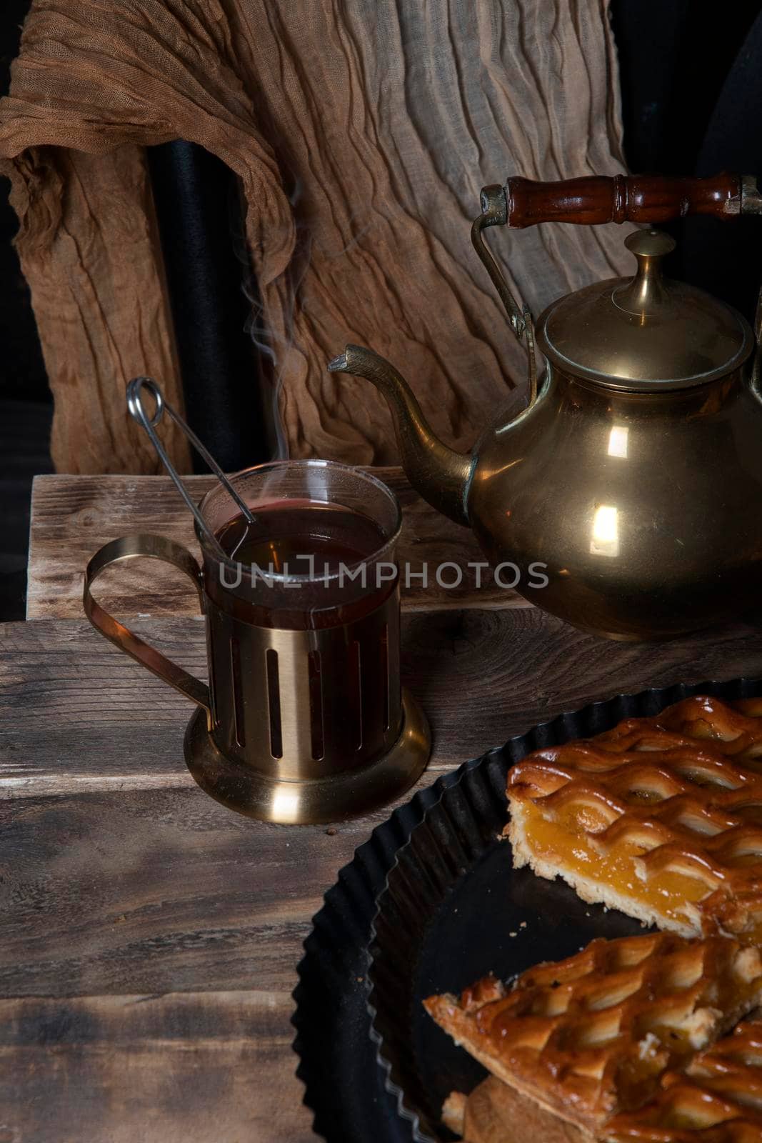 apricot pie with black tea on wooden table seasonal autumn still life. High quality photo