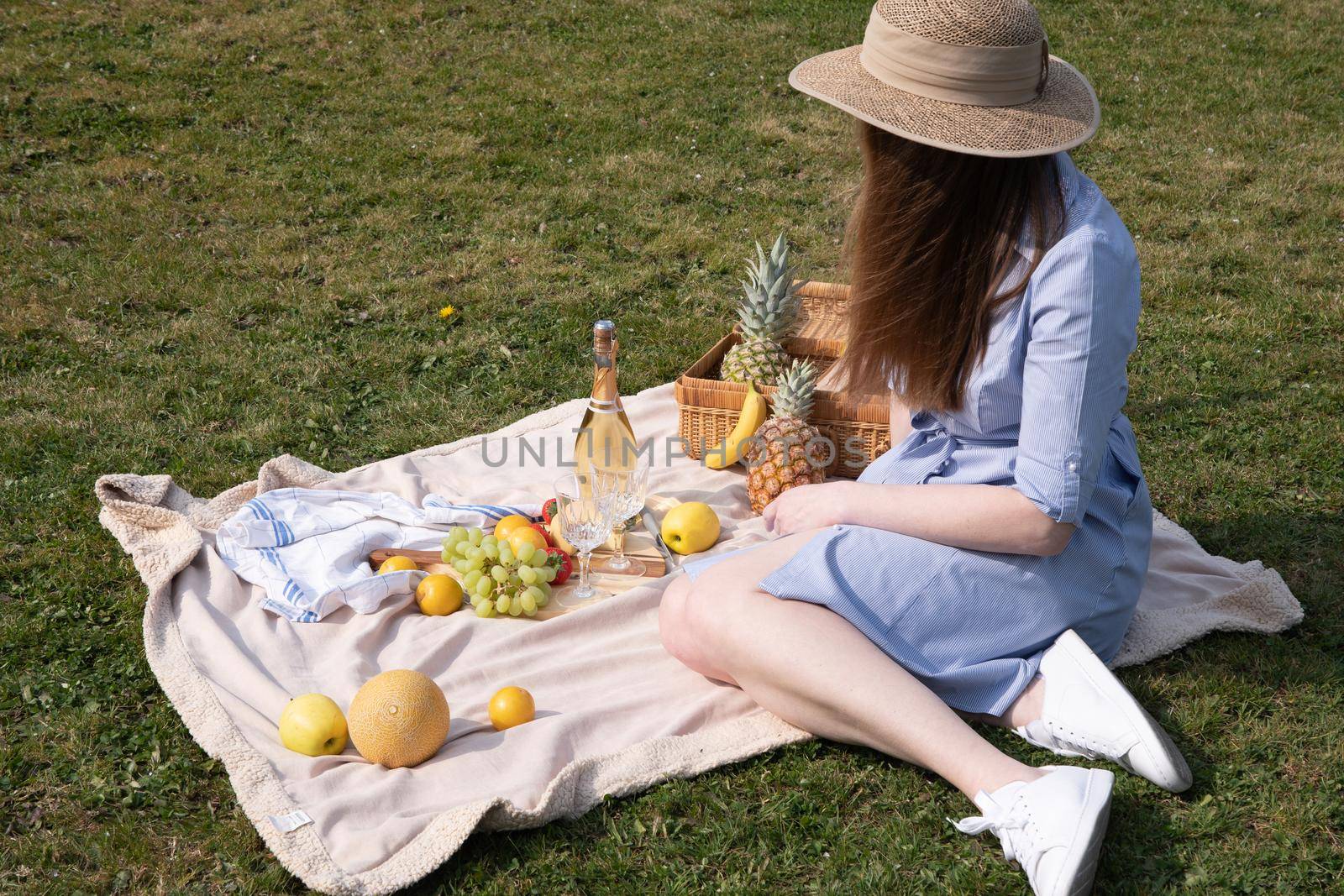a two young women in a similar blue dress is resting on a picnic, chees plate by KaterinaDalemans