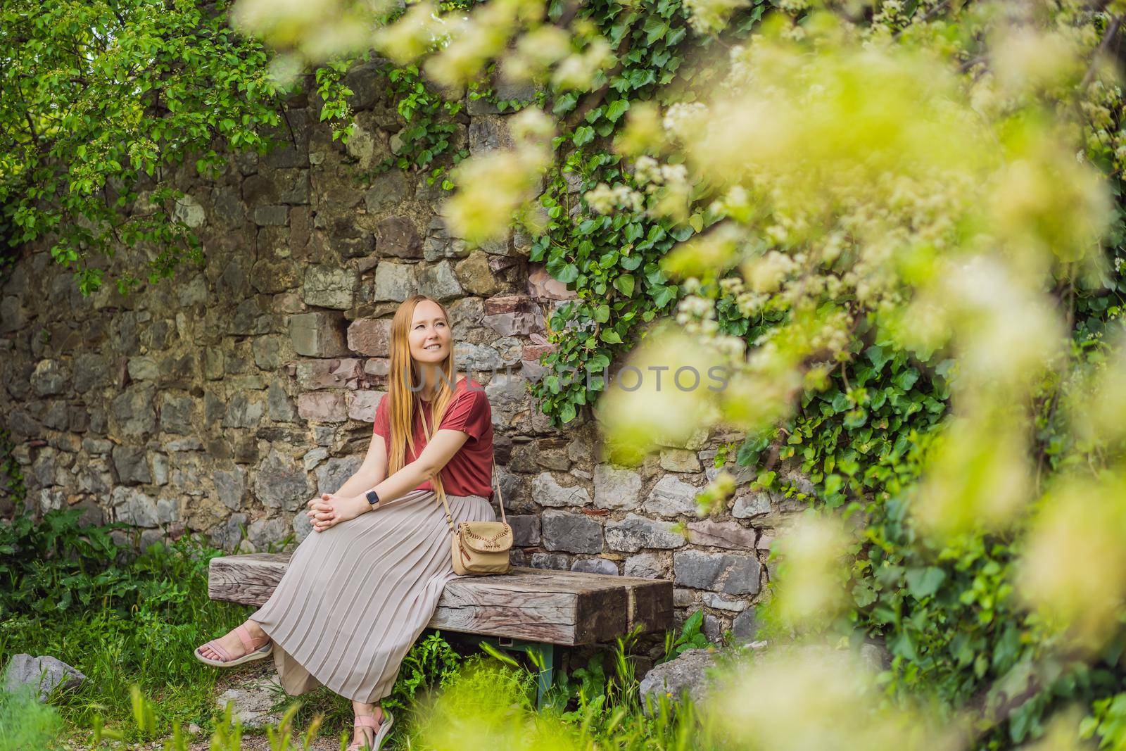 Woman tourist walks through the old town of Bar in Montenegro. Happy tourist walks in the mountains. Suburbs of the city of Bar, Montenegro, Balkans. Beautiful nature and landscape.