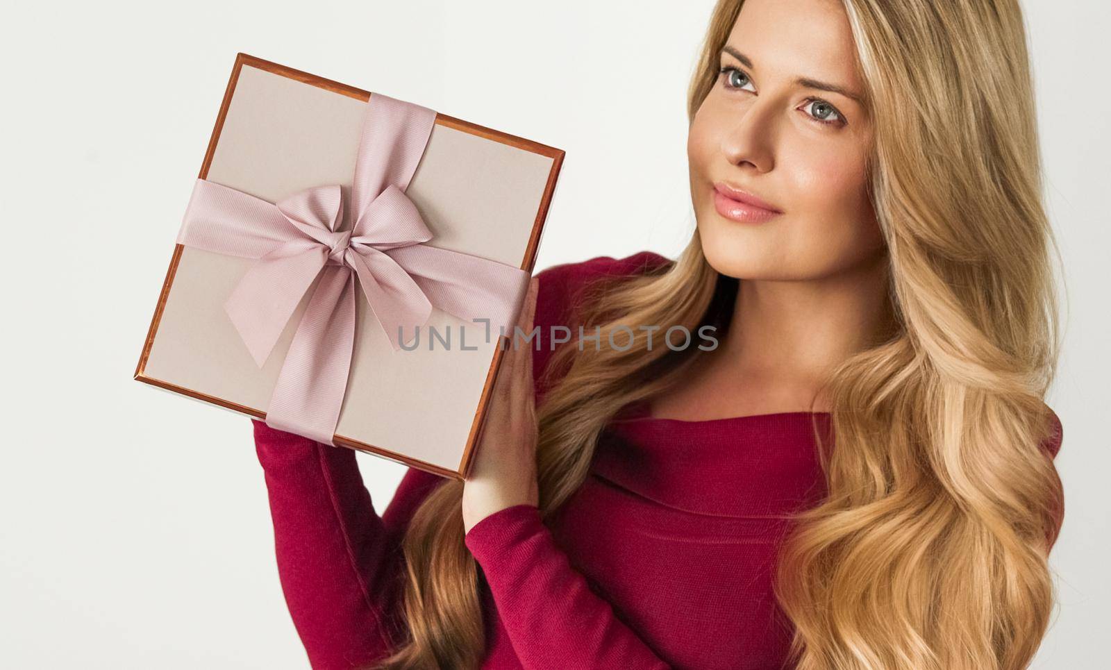 Holiday present for birthday, baby shower, wedding or luxury beauty box subscription delivery, happy woman holding a wrapped pink gift by Anneleven