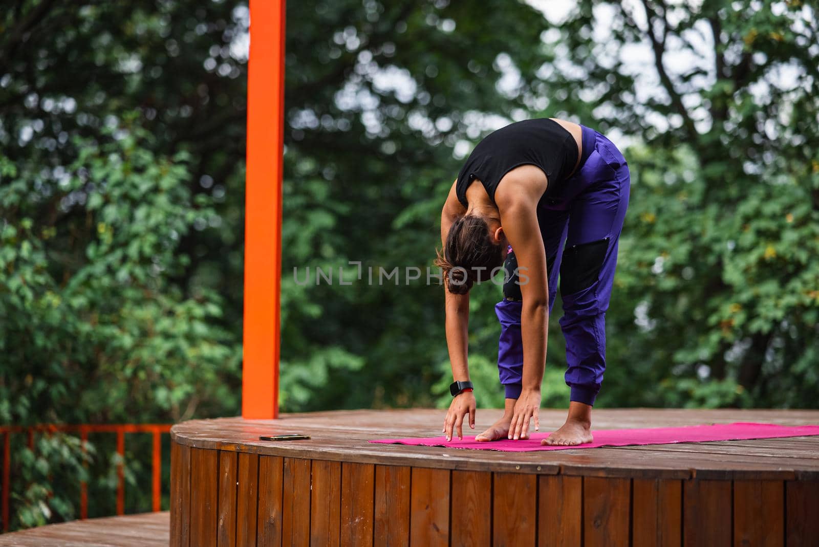 Morning workout. Healthy lifestyle concept. Young attractive woman in sportswear does stretching hand before exercise. Warm up