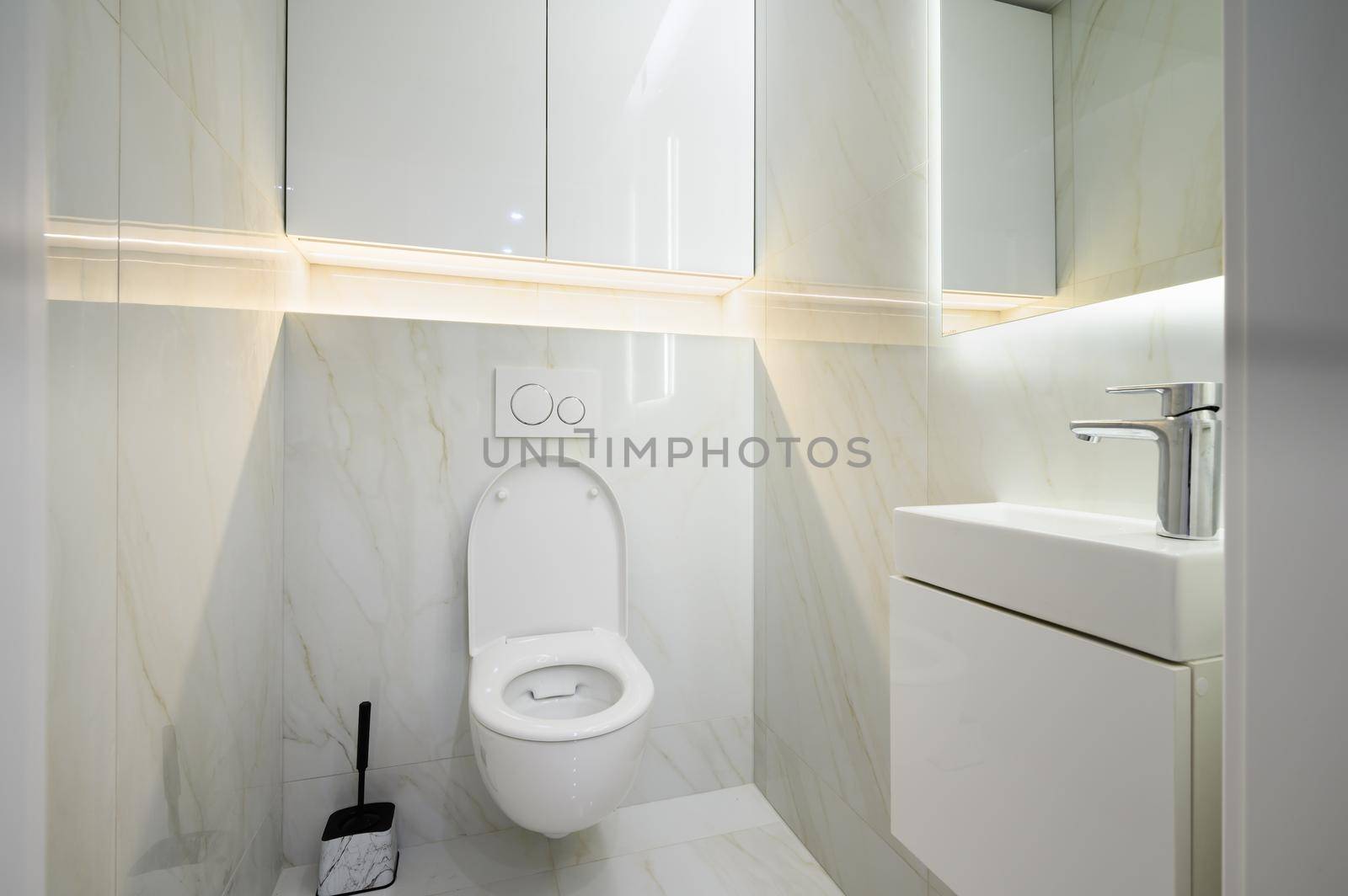 New ceramic toilet bowl in a white toilet room interior