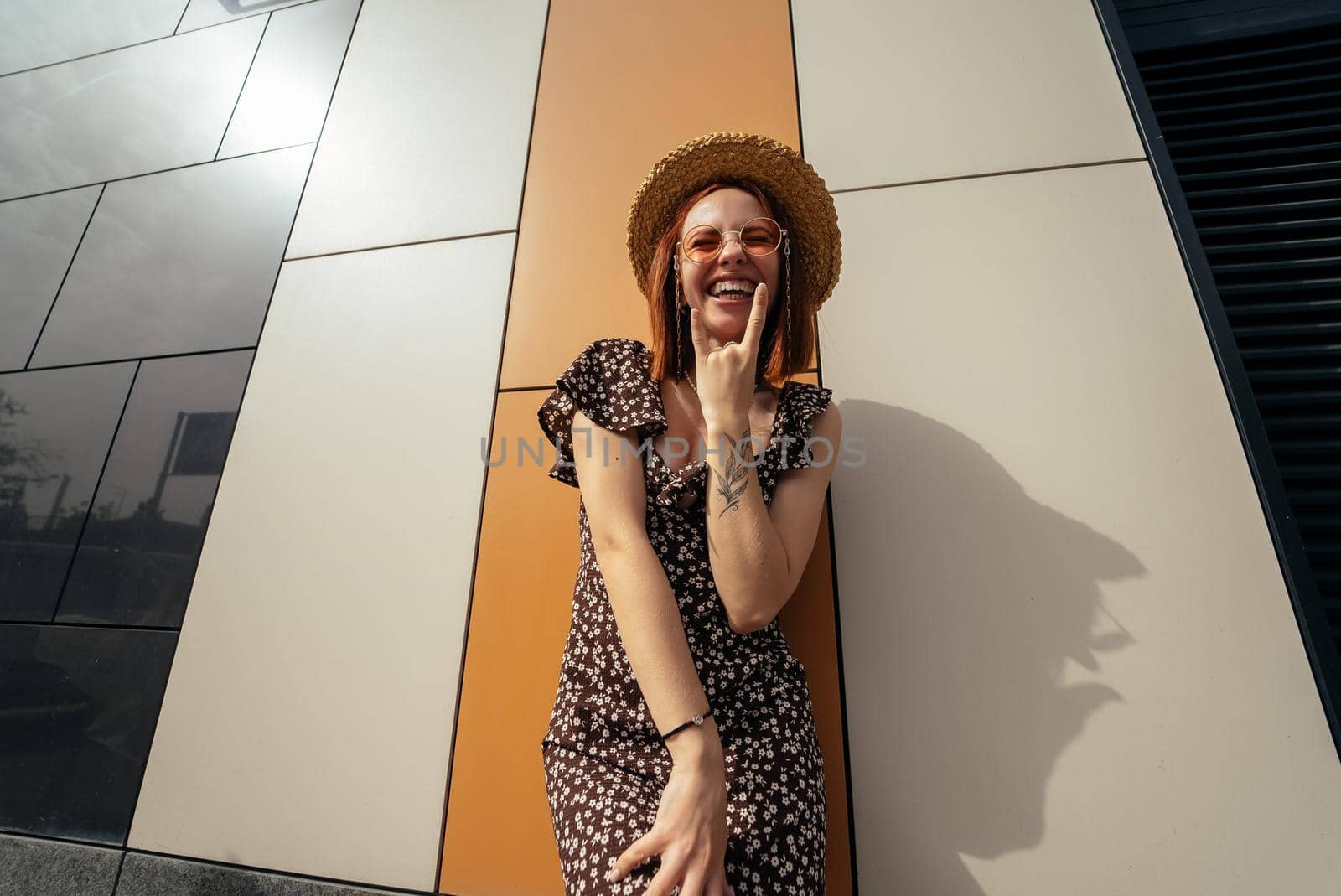 Cute young woman with a lovely sense of humour in an urban street laughing at the camera