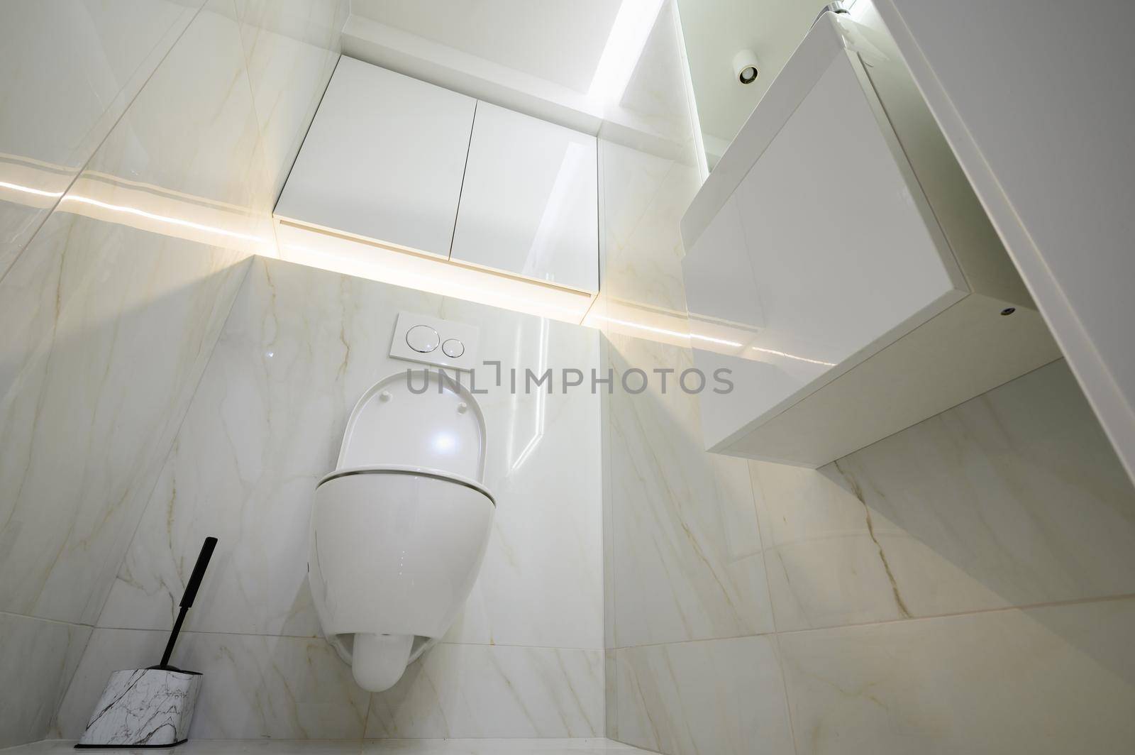 New ceramic toilet bowl in a white toilet room interior