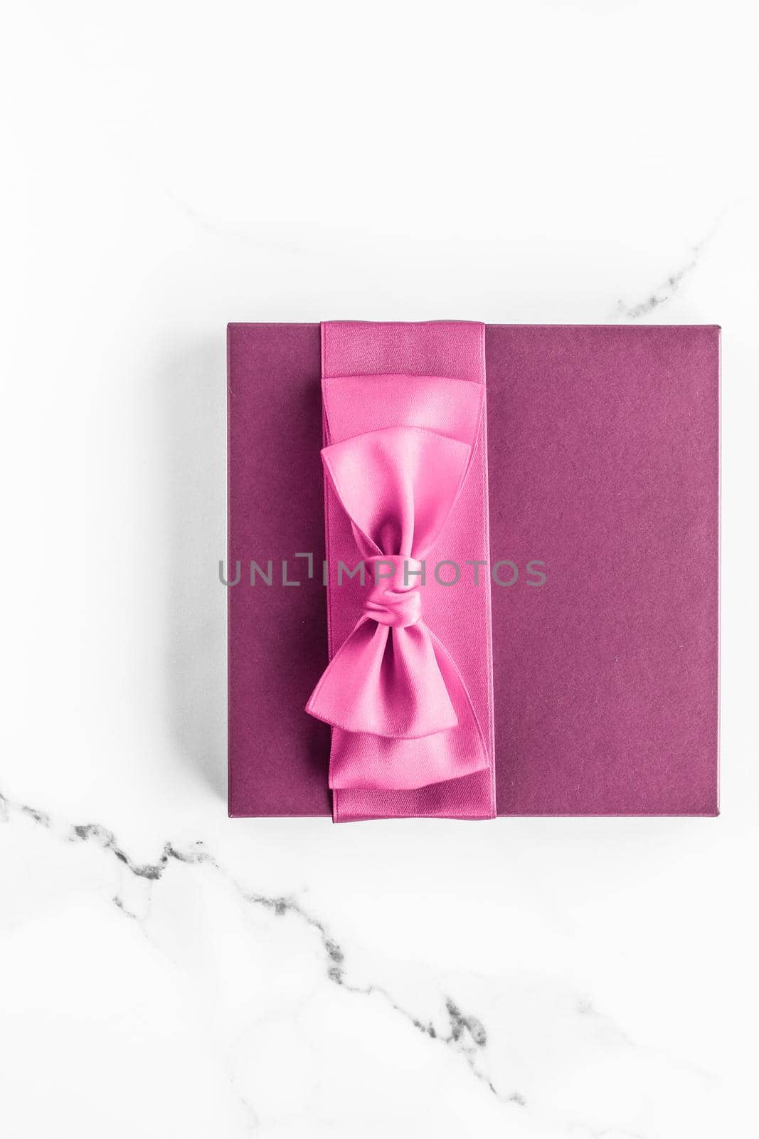 Birthday, wedding and girly branding concept - Pink gift box with silk bow on marble background, girl baby shower present and glamour fashion gift for luxury beauty brand, holiday flatlay art design