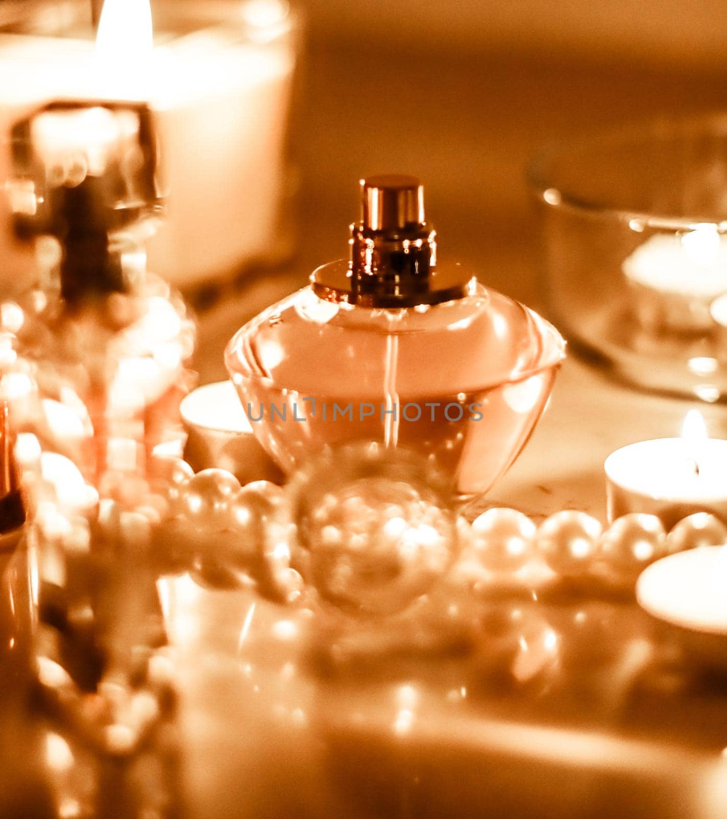 Perfumery, cosmetics branding and luxe concept - Perfume bottle and vintage fragrance on glamour vanity table at night, pearls jewellery and eau de parfum as holiday gift, luxury beauty brand present