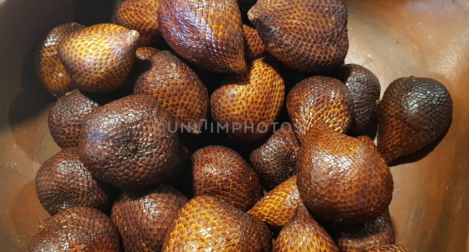 group of snake fruit or called salak in local indonesian language is a type of palm fruit commonly eaten also known as sala, the scientific name is Salacca zalacca.