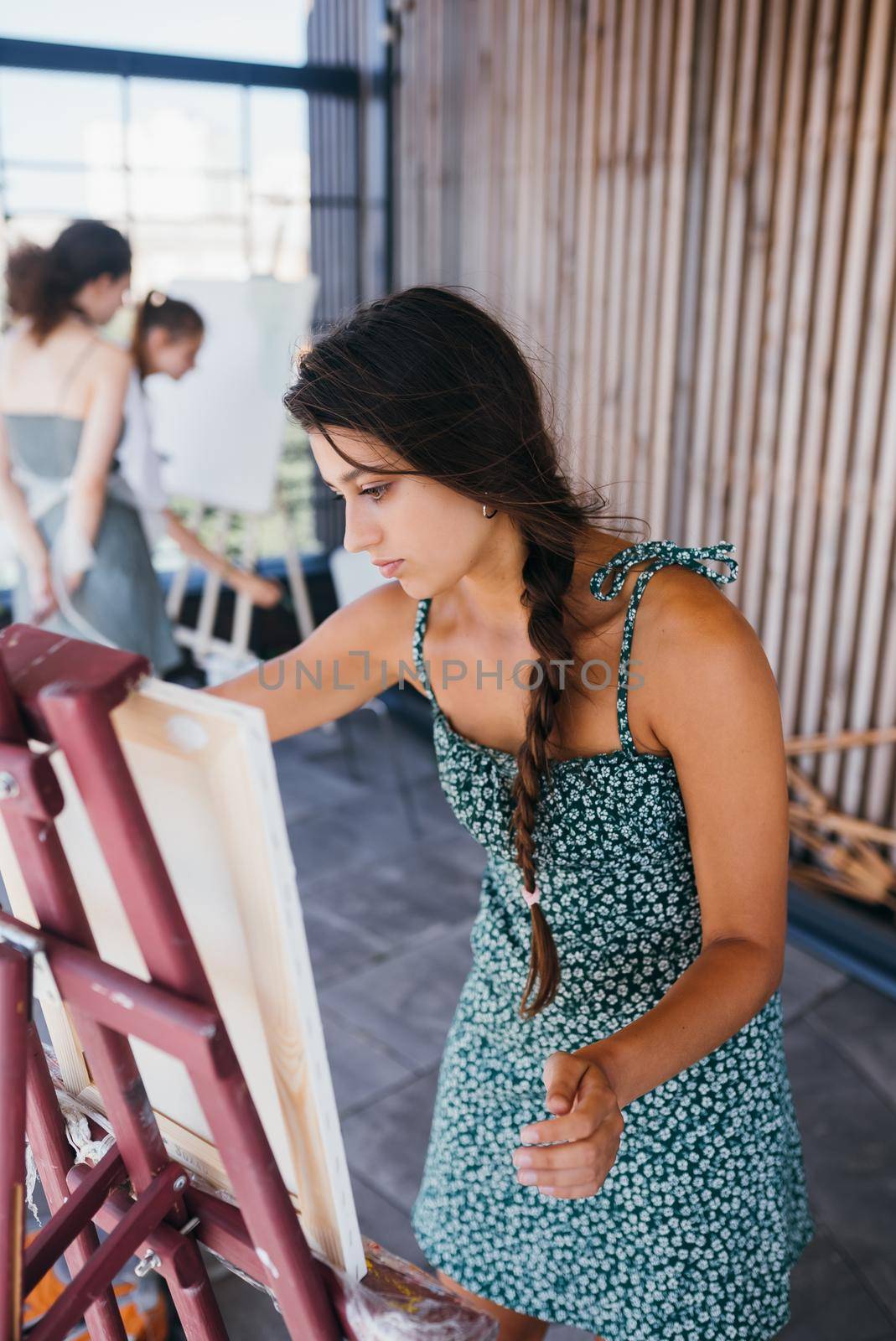 Female artist painting picture in workshop