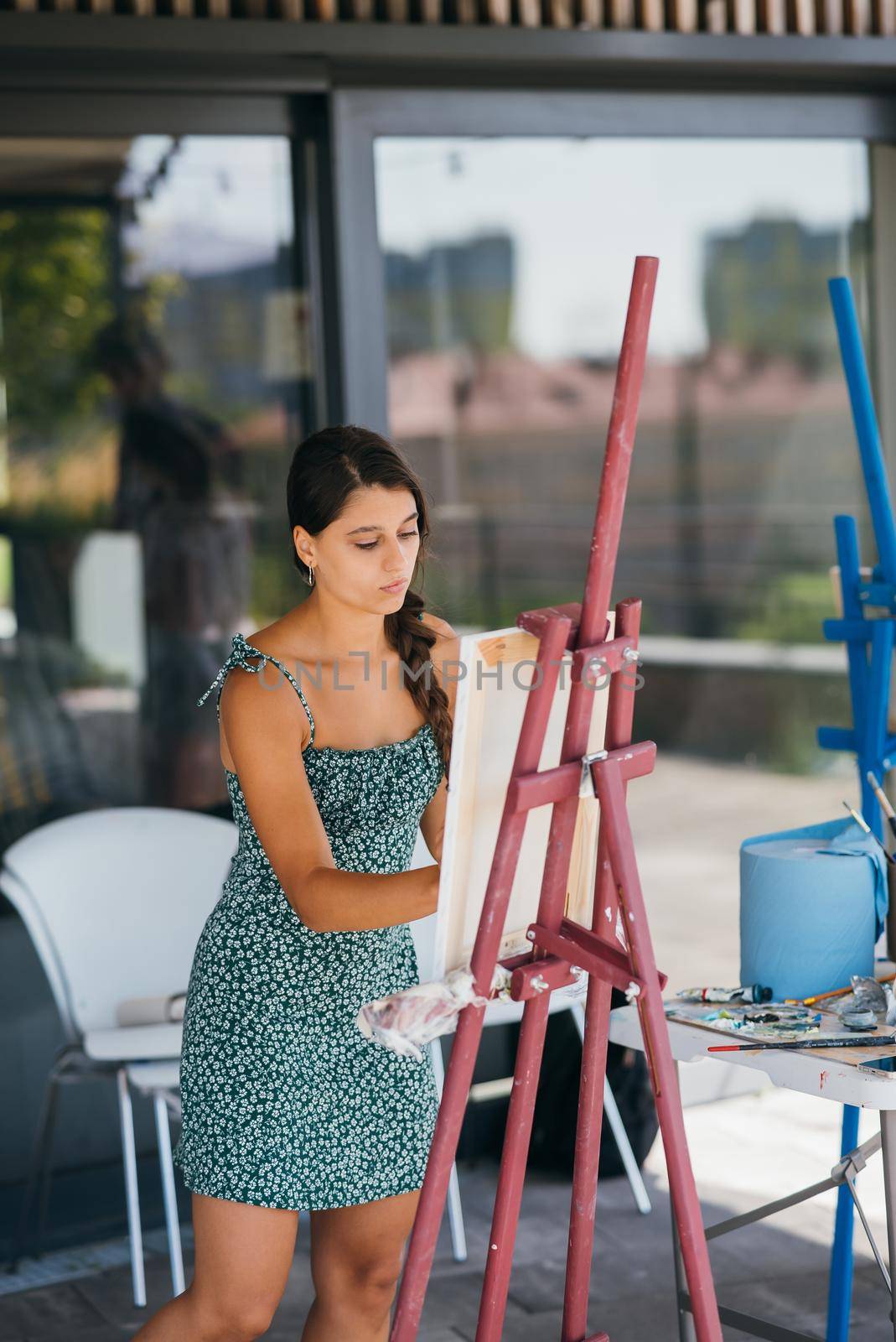 Female artist painting picture in workshop