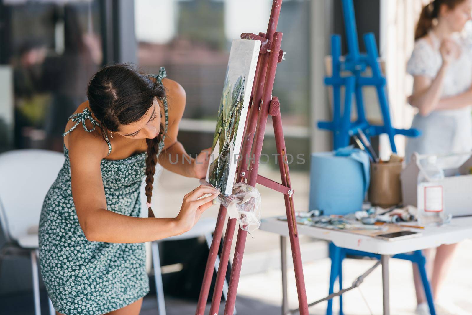 Female artist painting picture in workshop
