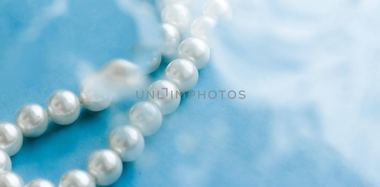 Coastal jewellery fashion, pearl necklace under blue water background, glamour style present and chic gift for luxury jewelery brand, holiday banner design by Anneleven