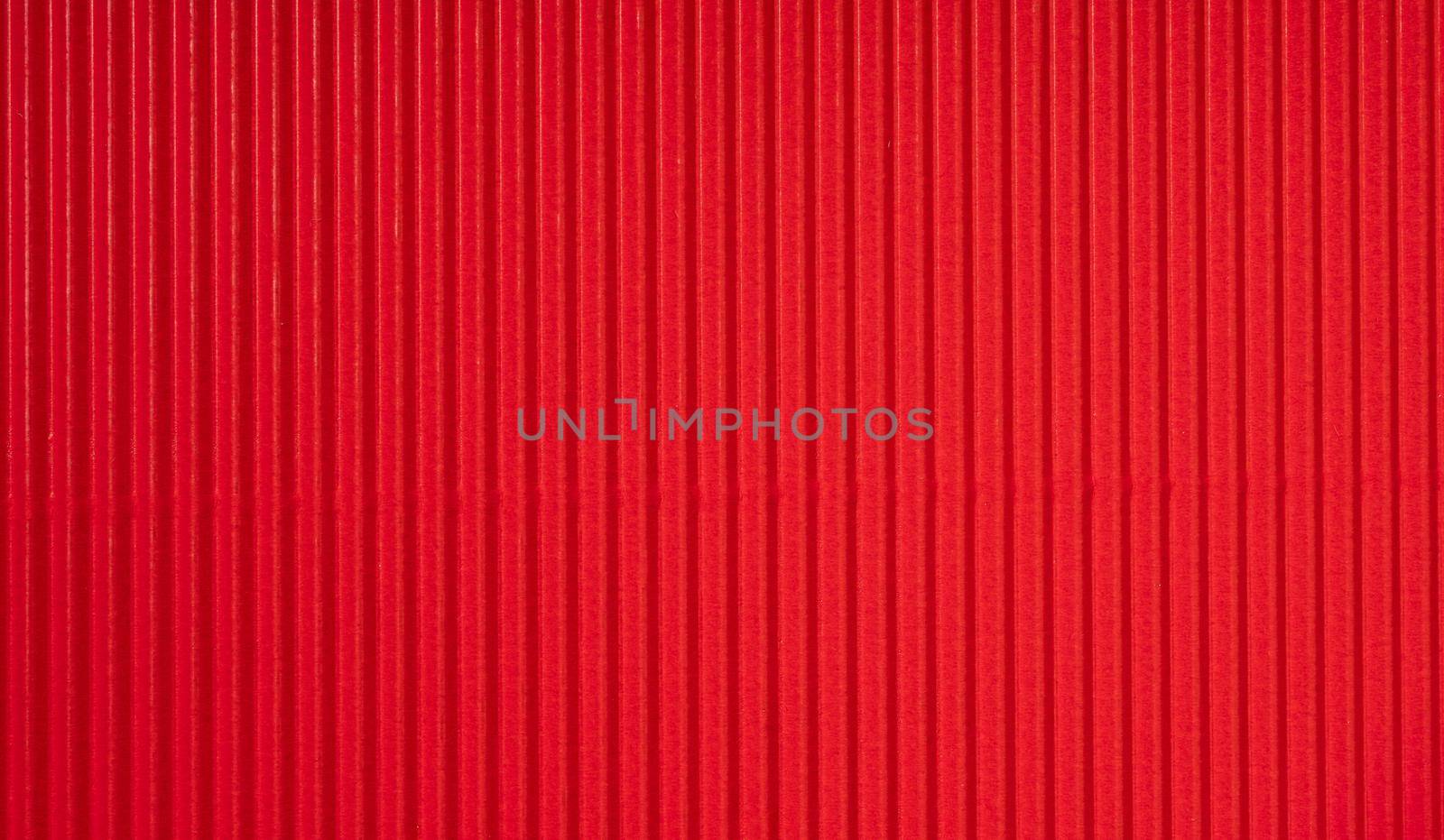 Decorative background. Background texture of corrugated red cardboard.