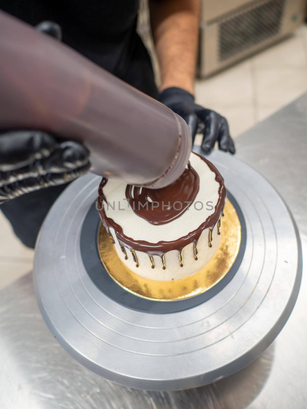decorating a frosted cake with chocolate and nutella