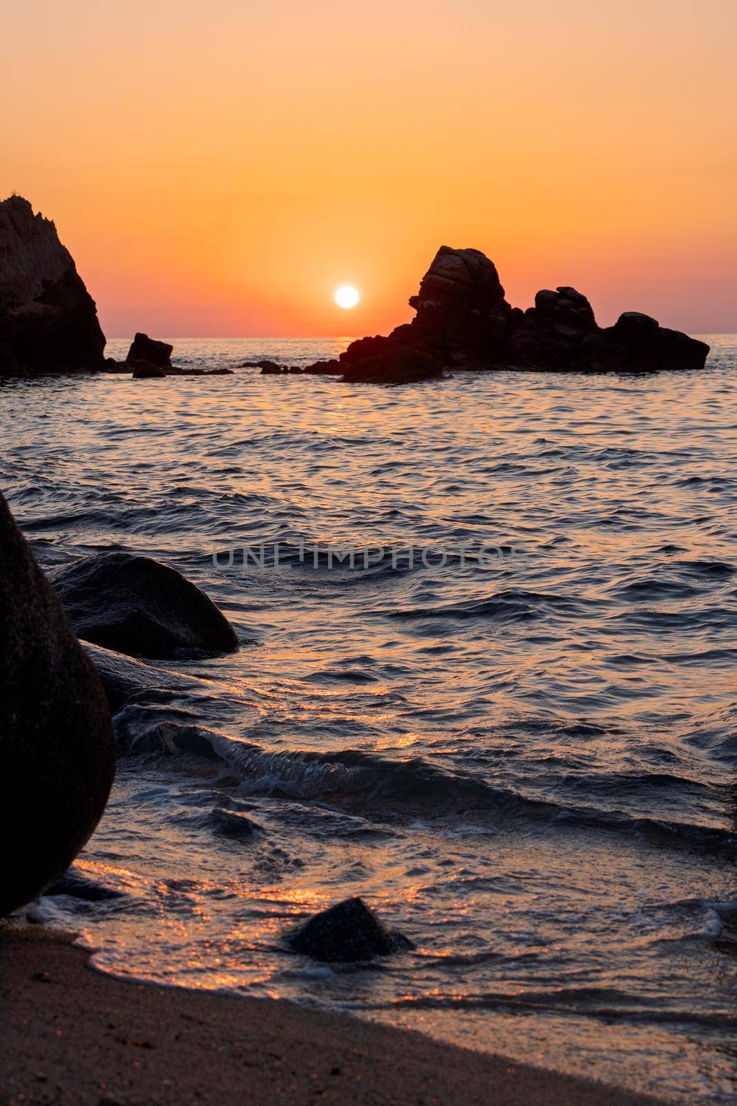 Beautiful view of orange sunset seascape with rocks in Italy. Colorful sunrise landscape by photolime