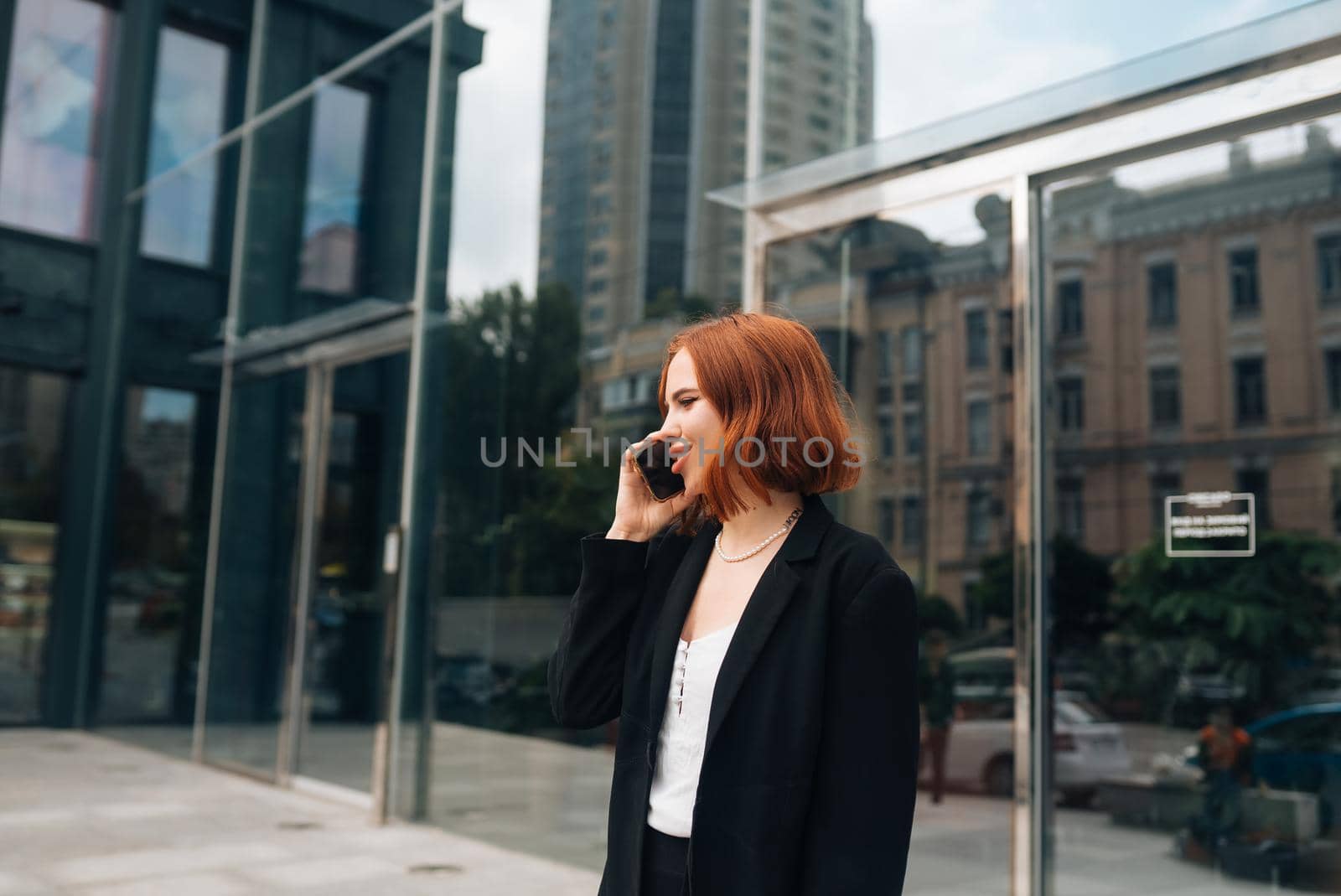 A beautiful redhead business woman on the phone at work