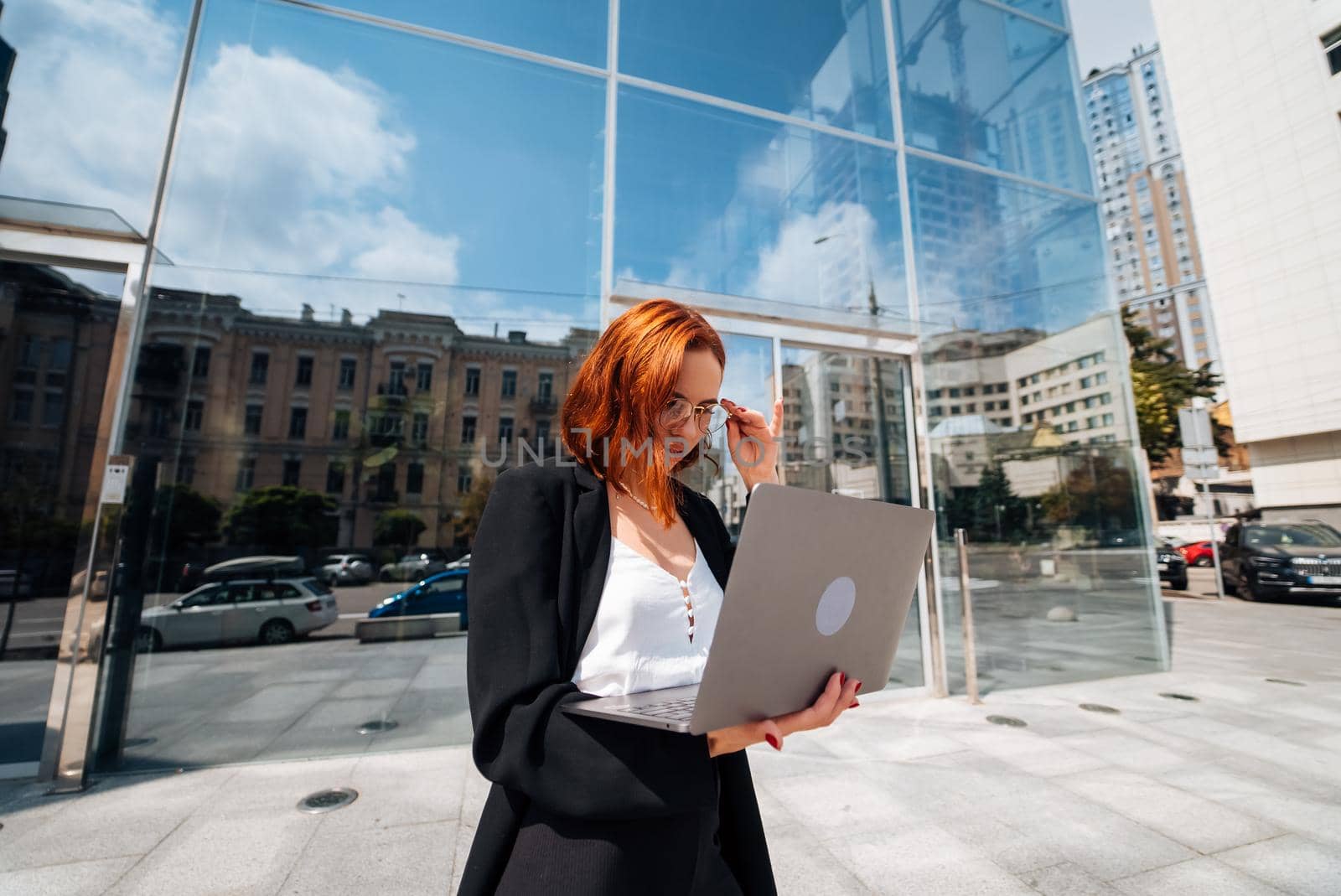 Smiling female looking at her laptop outdoors, modern lifestyle, connection, business, coffee break, communication, web chat, social media, video conference concept.