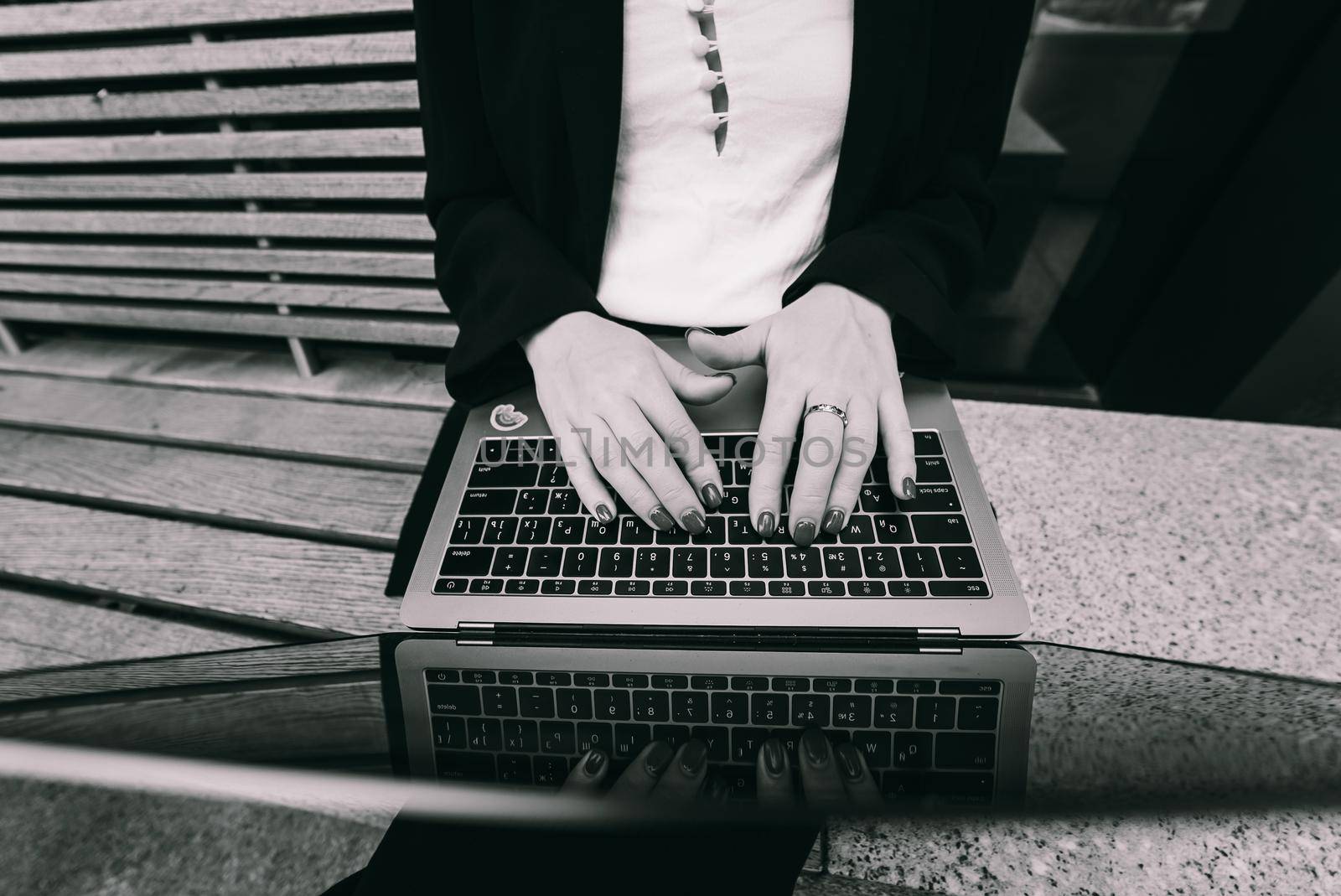 Close up image of woman hands typing and writing on laptop, working on cafe.