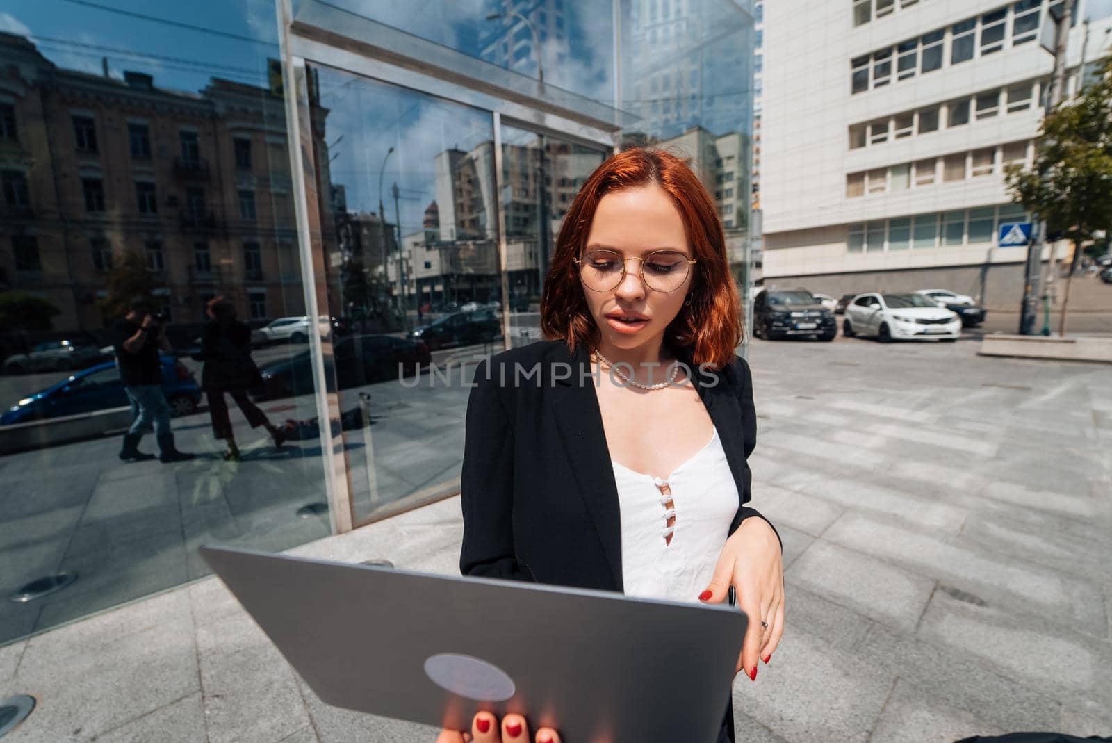 Smiling female looking at her laptop outdoors, modern lifestyle, connection, business, coffee break, communication, web chat, social media, video conference concept.