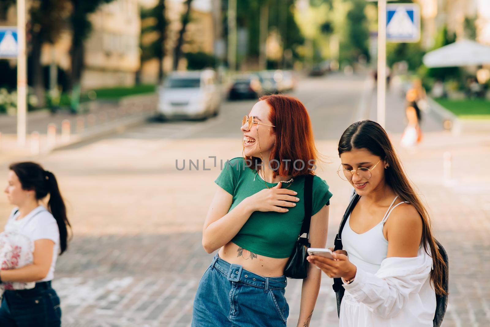 Two tourist friends consulting an online guide on a smart phone