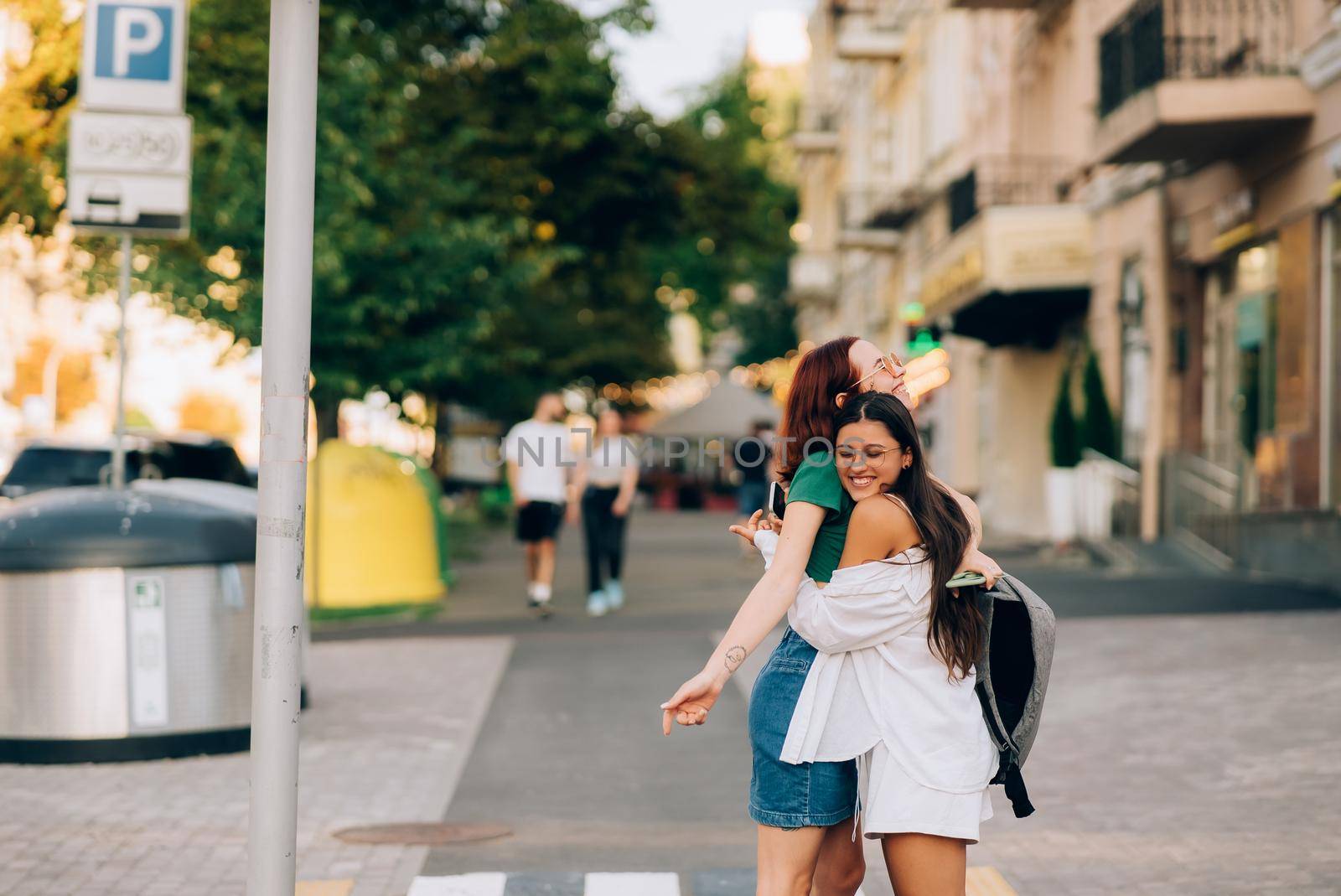 Meeting of two friends hugging in the street